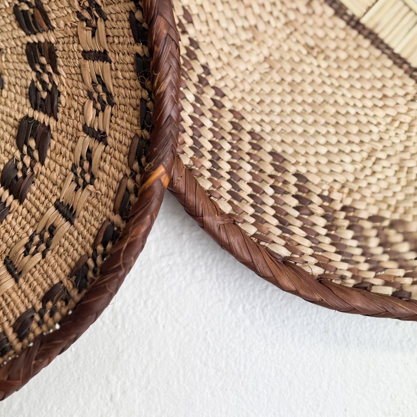 Close-up of a woven basket with a textured pattern on a white background