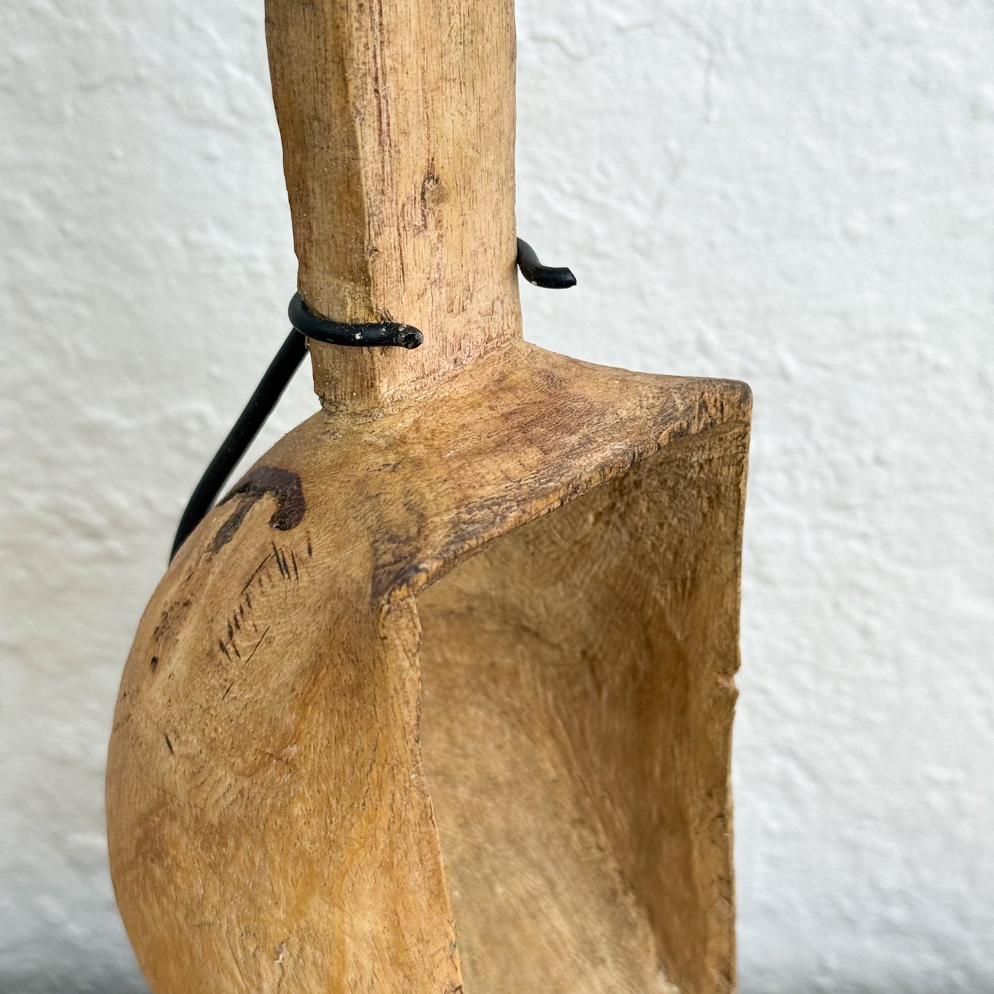 Wooden spatula with a handle on a textured white background