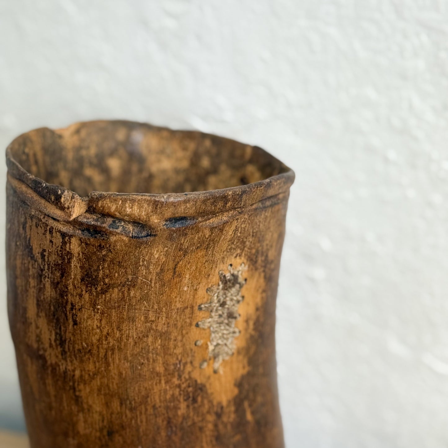 Close-up of a worn wooden container on a white background