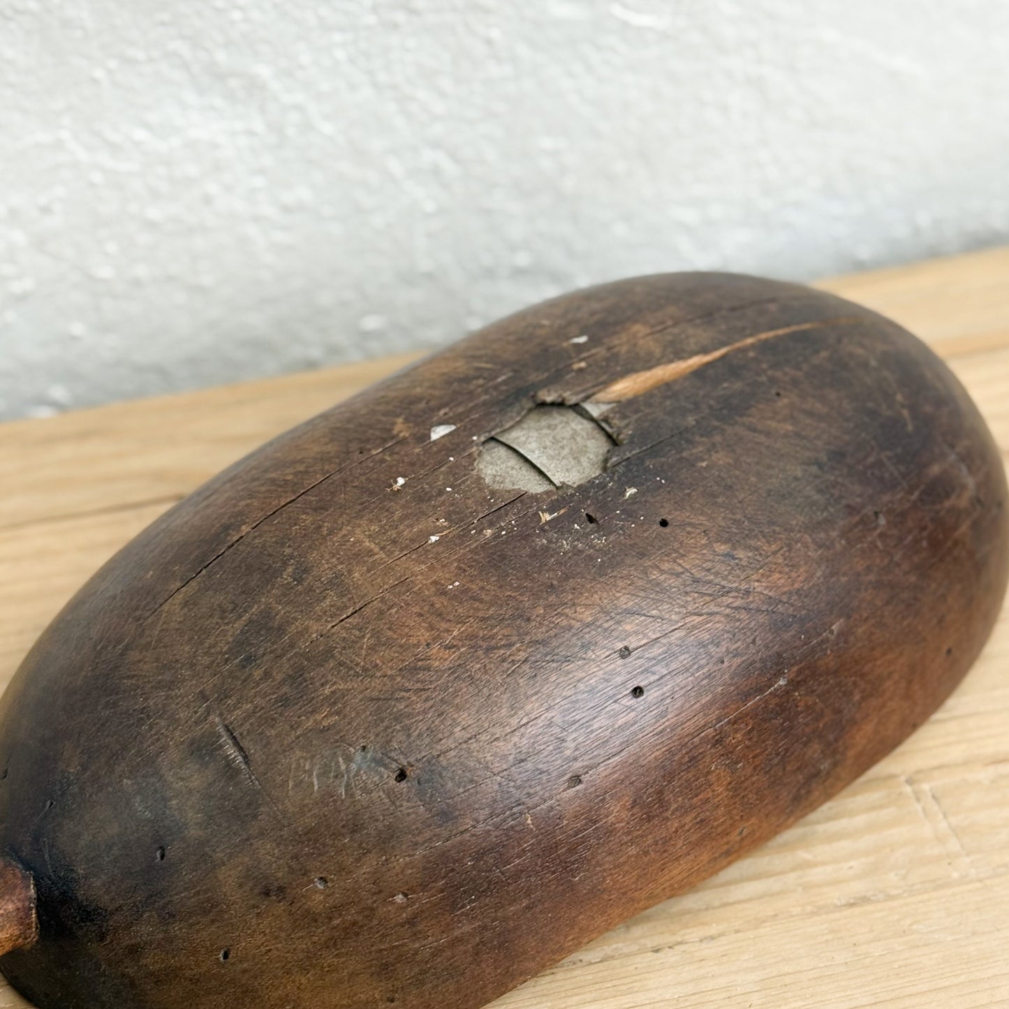 Wooden pestle on a wooden surface with a white background
