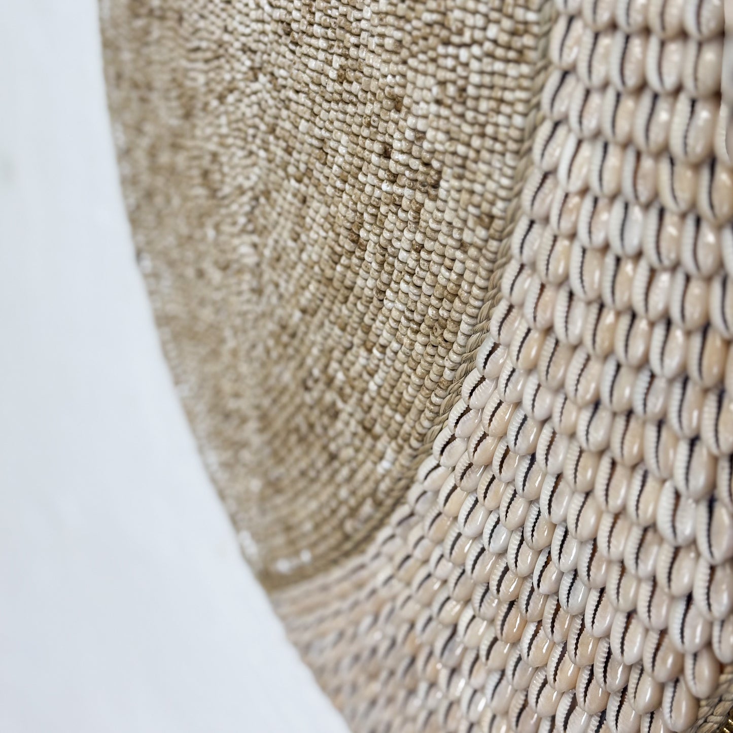Close-up of a woven mat with a textured pattern on a white background