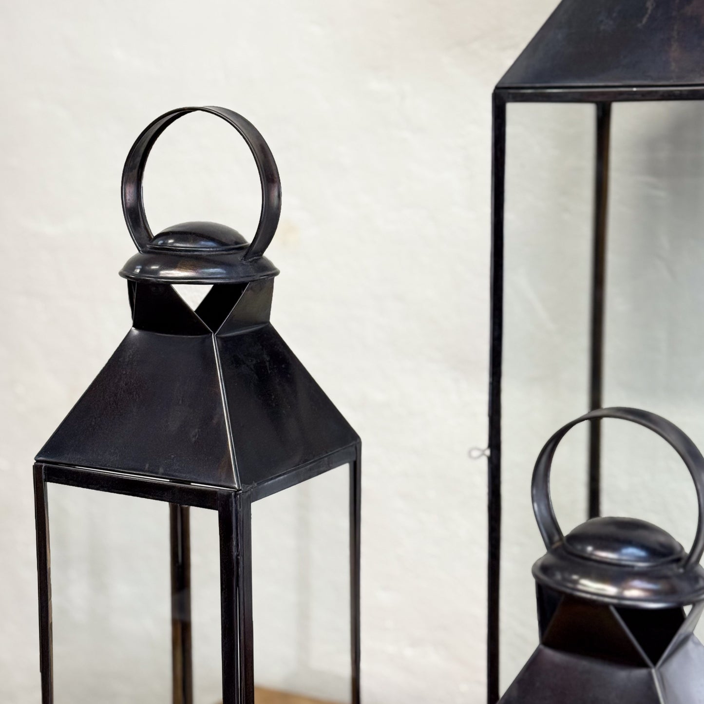 Black metal lanterns on a neutral background