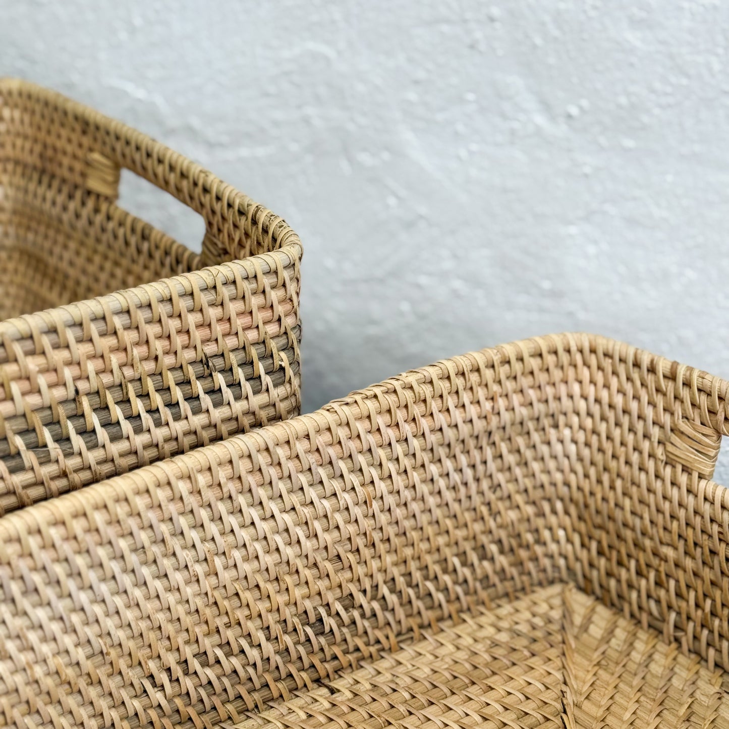 Two woven baskets on a light gray background
