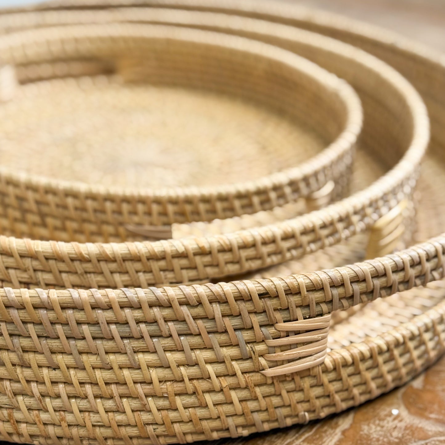 Set of woven baskets of different sizes on a wooden surface