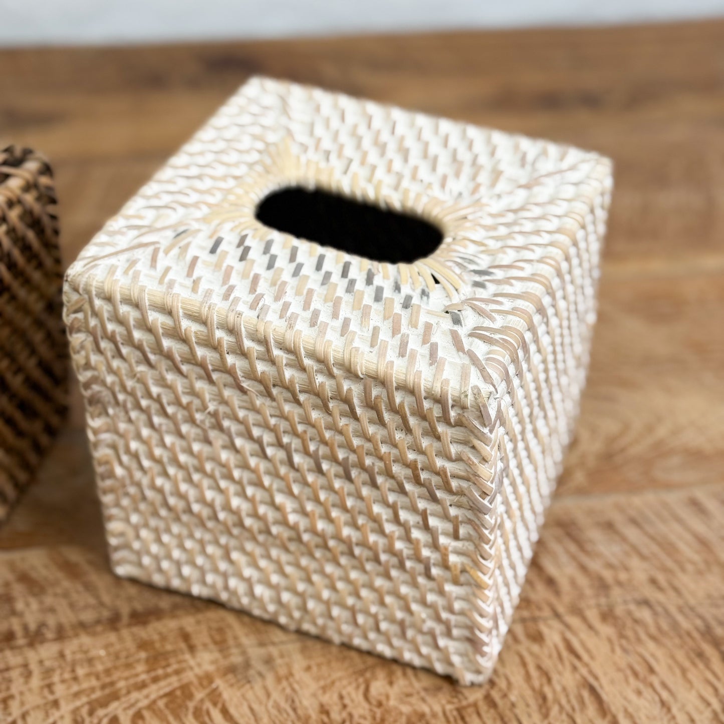 Woven tissue box cover on a wooden surface