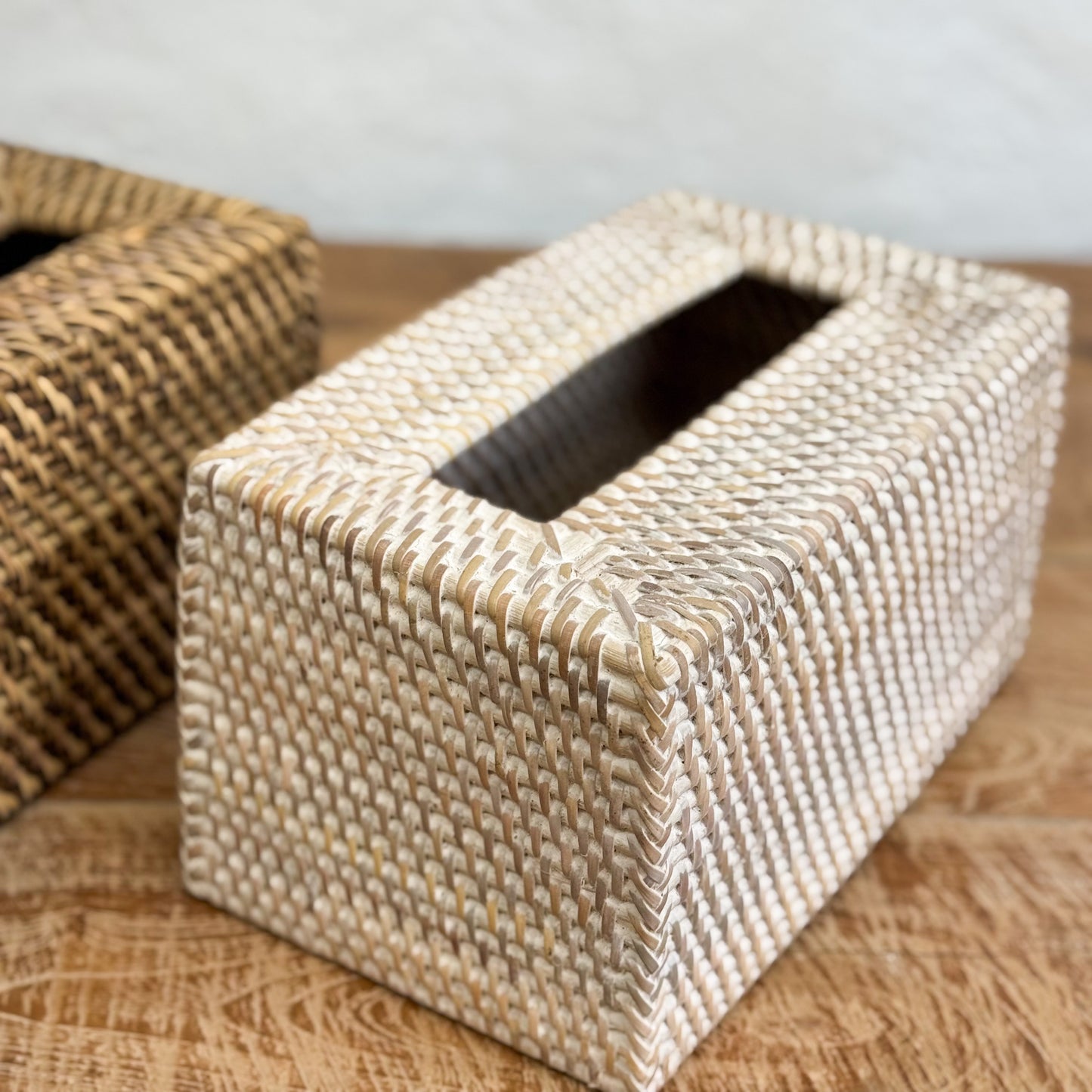 Woven tissue box cover on a wooden surface