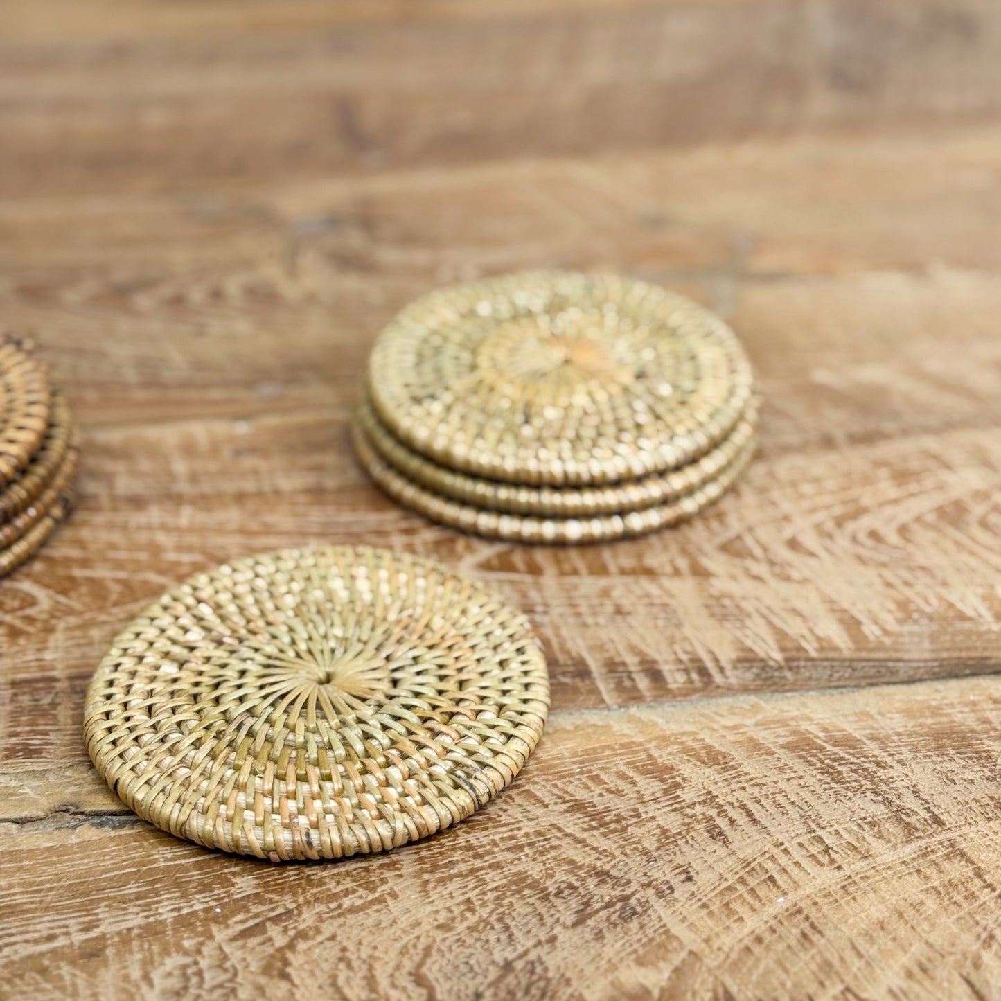 Woven coasters on a wooden surface