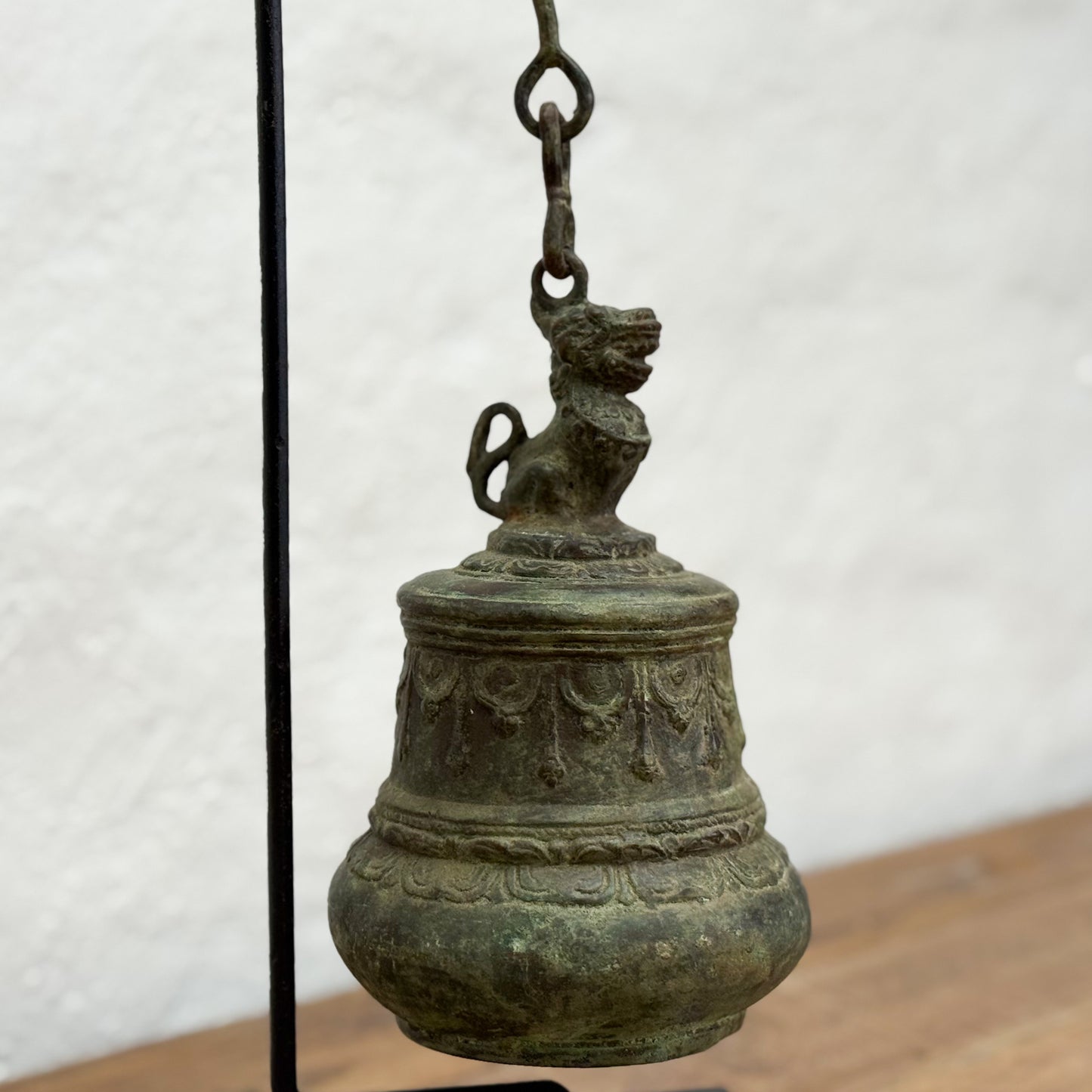 Bronze bell with decorative carvings on a white background