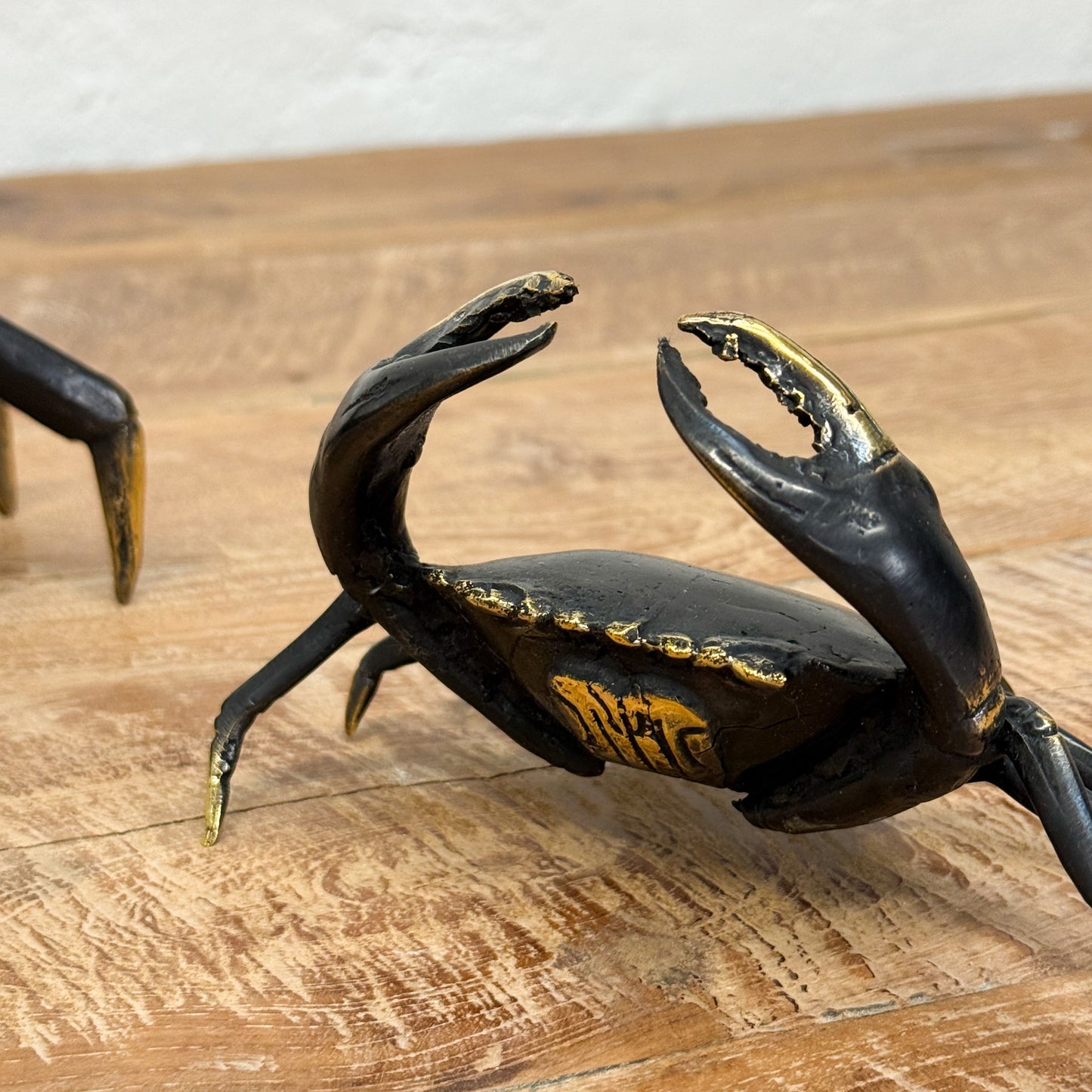 Decorative crab sculpture on a wooden surface