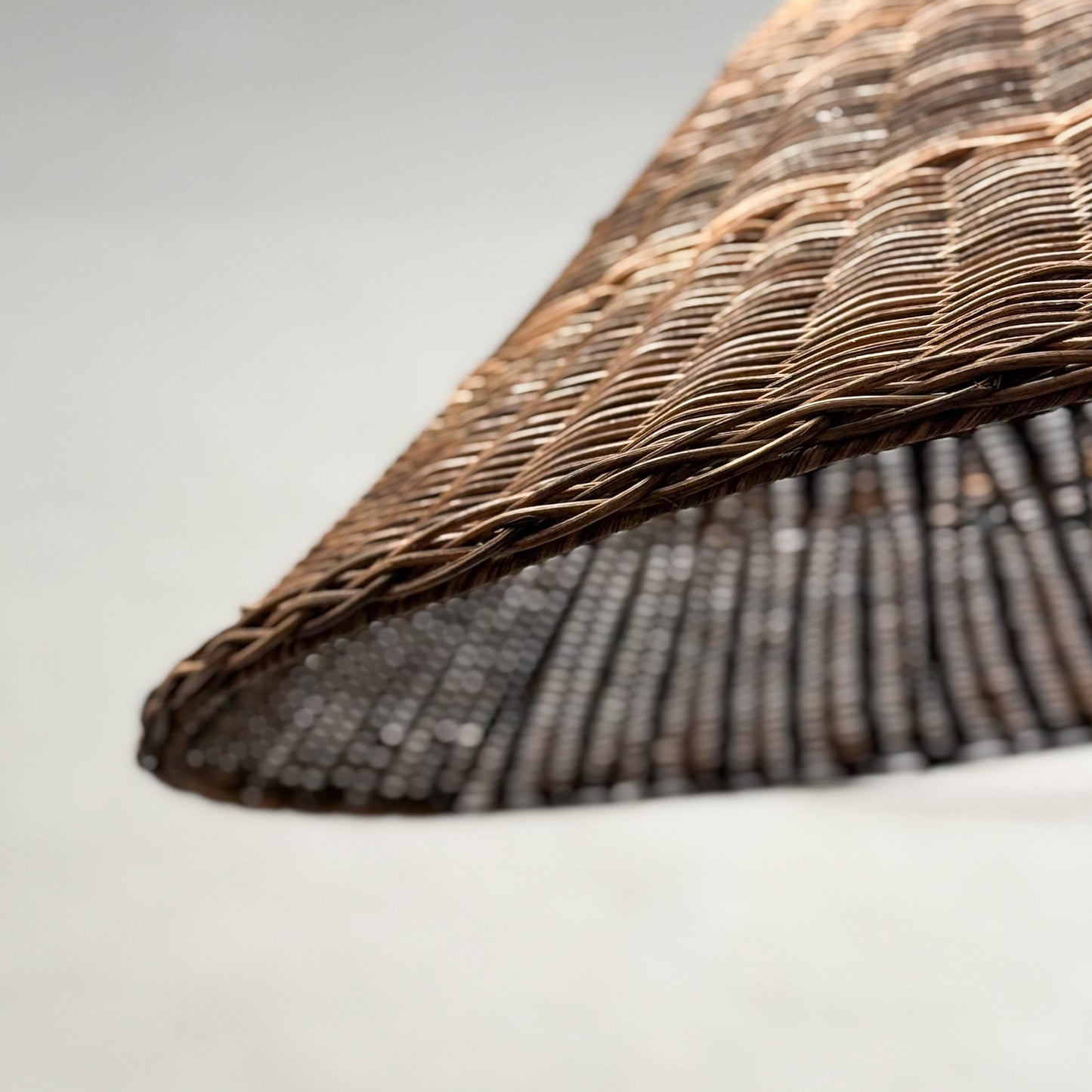 Close-up of a wicker chair with a textured surface on a light background