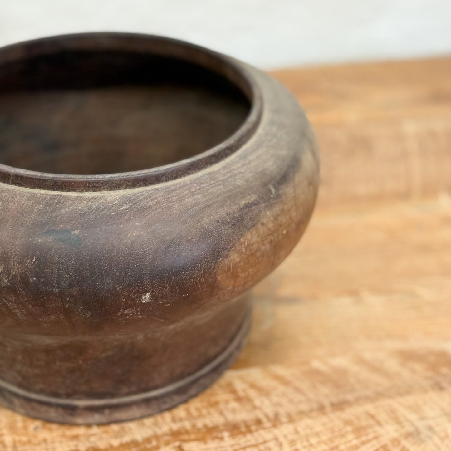 Brown ceramic pot on a wooden surface