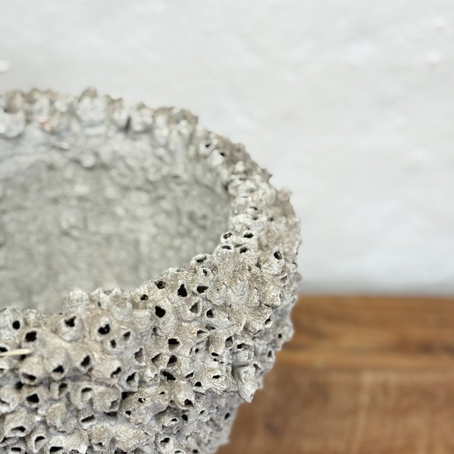 Decorative stone bowl on a wooden surface with a blurred background