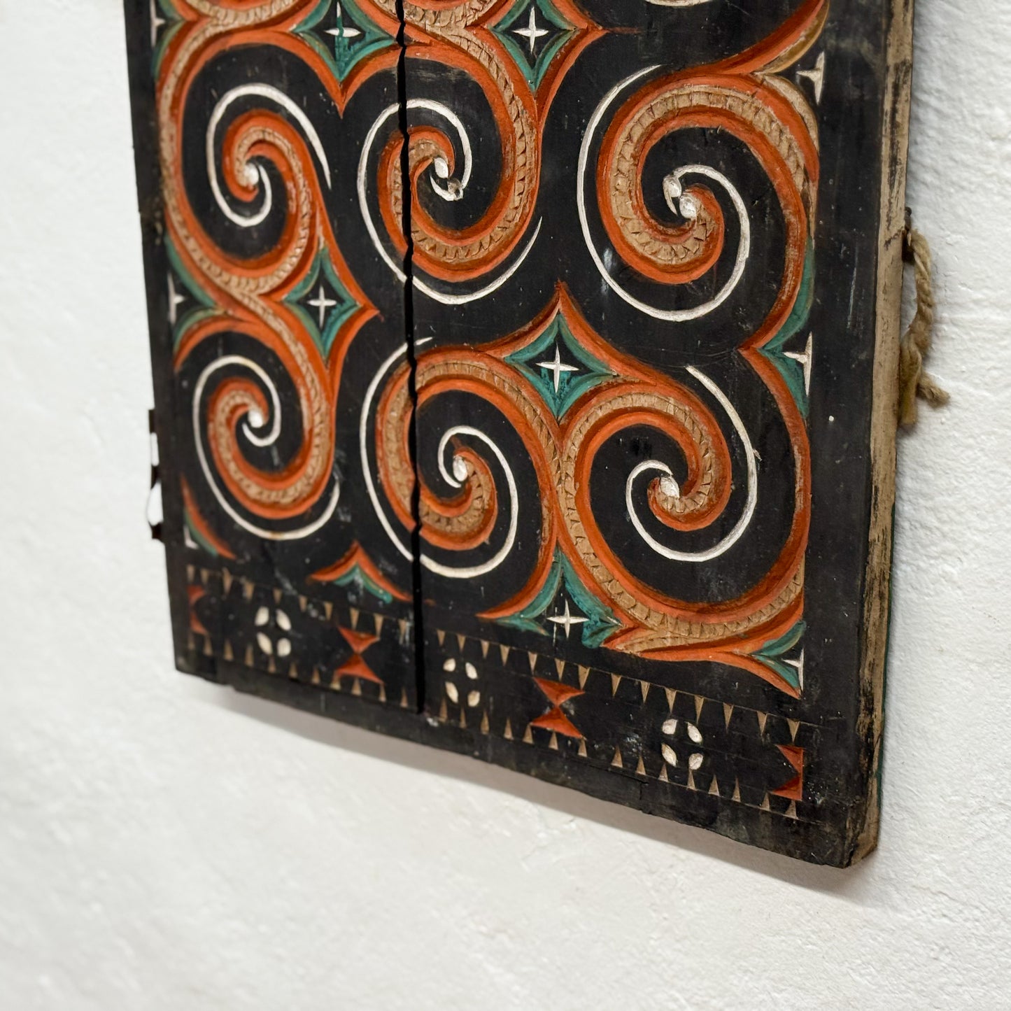 Decorative wooden panel with intricate patterns on a white background