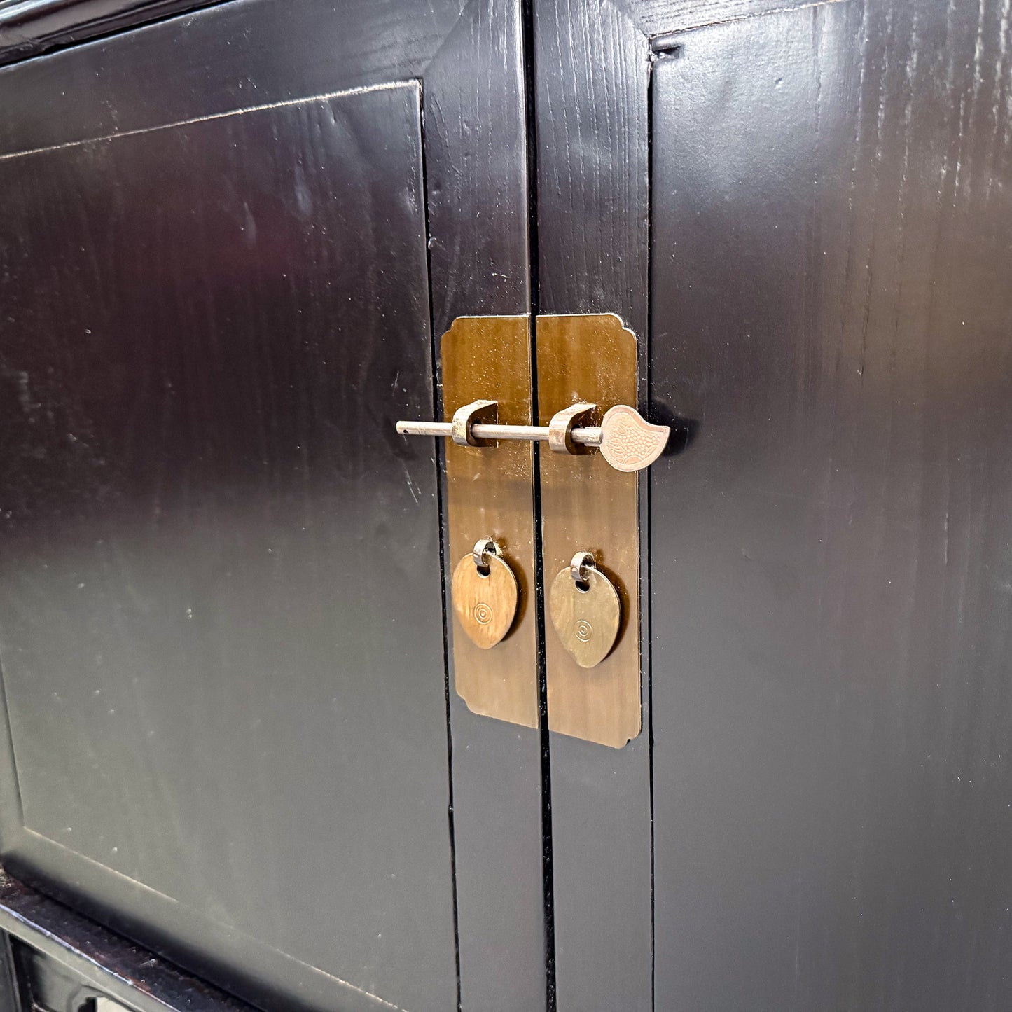 Black cabinet with brass handle and lock