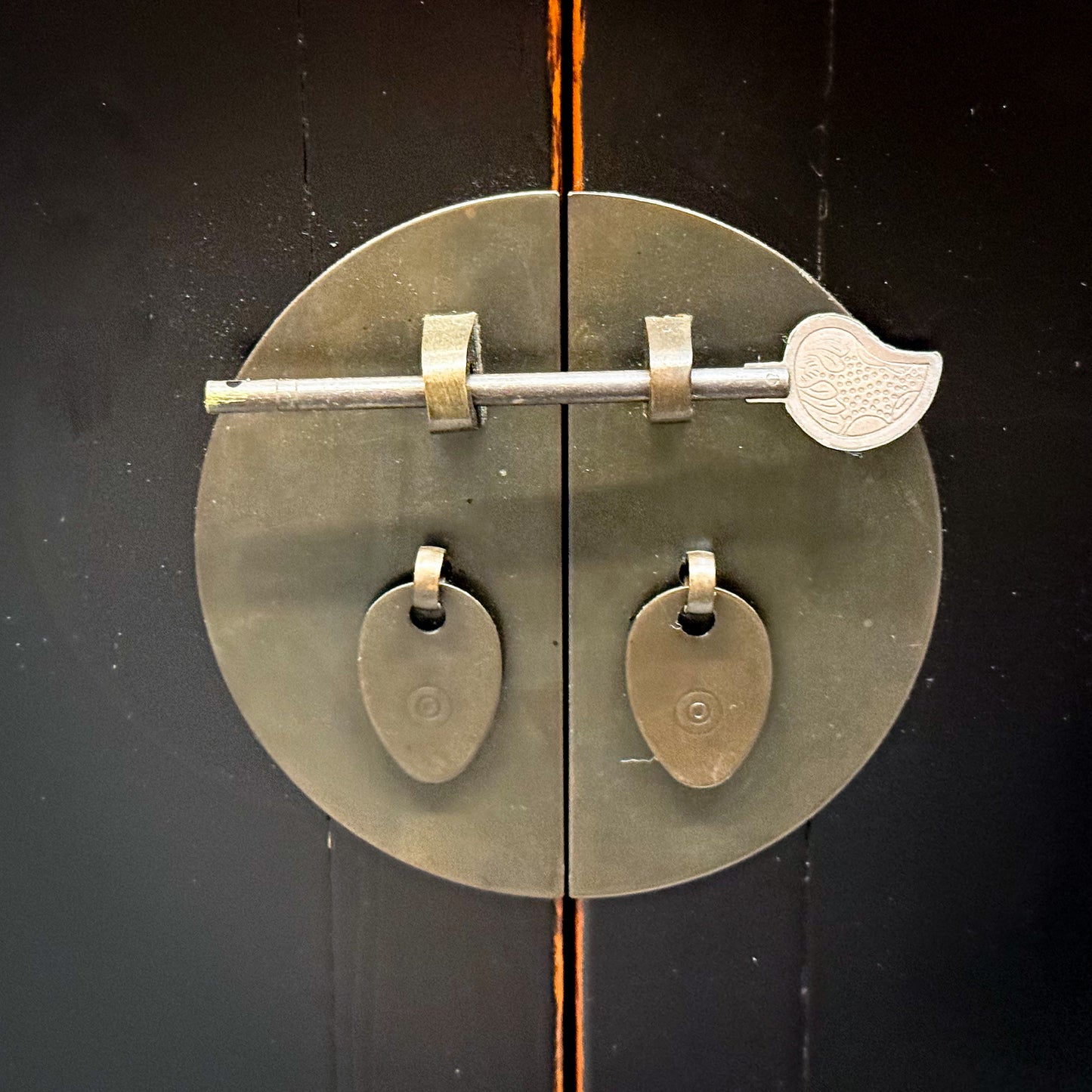Decorative metal handle on a wooden door