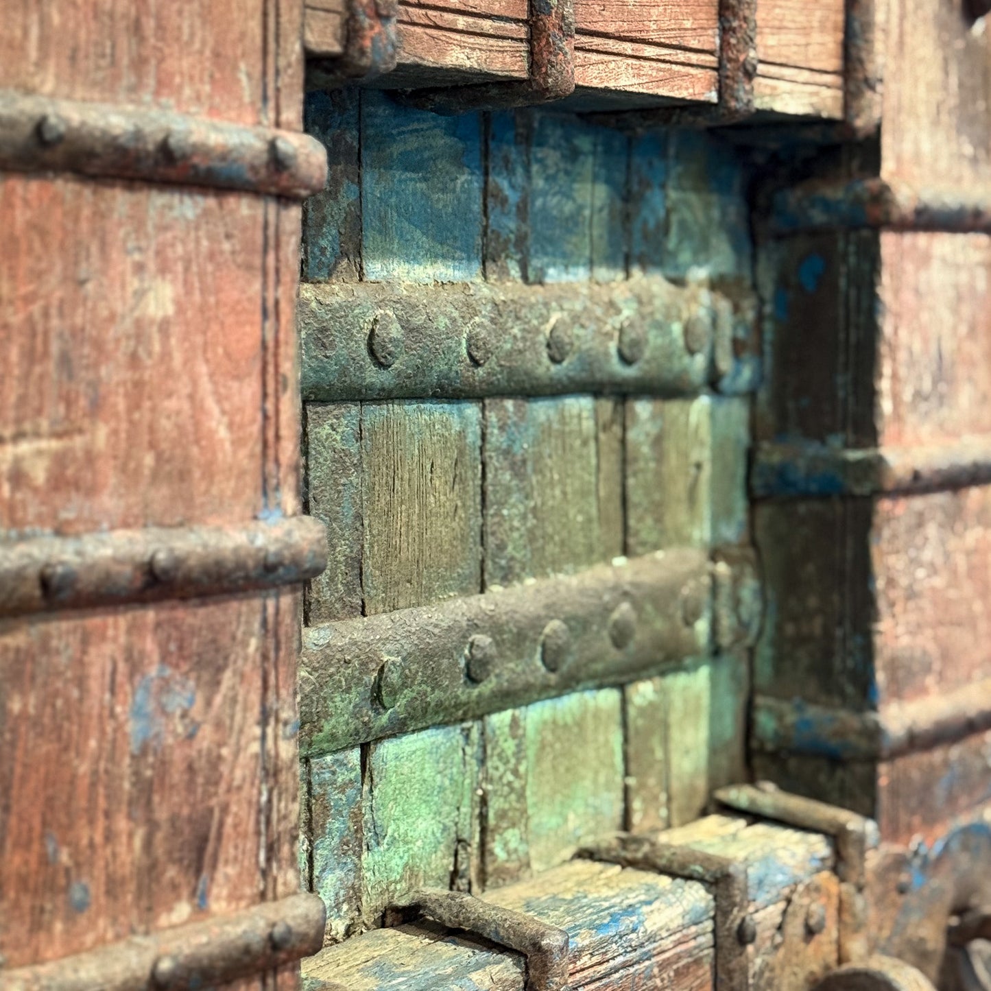 Close-up of a rusty metal gate with peeling paint
