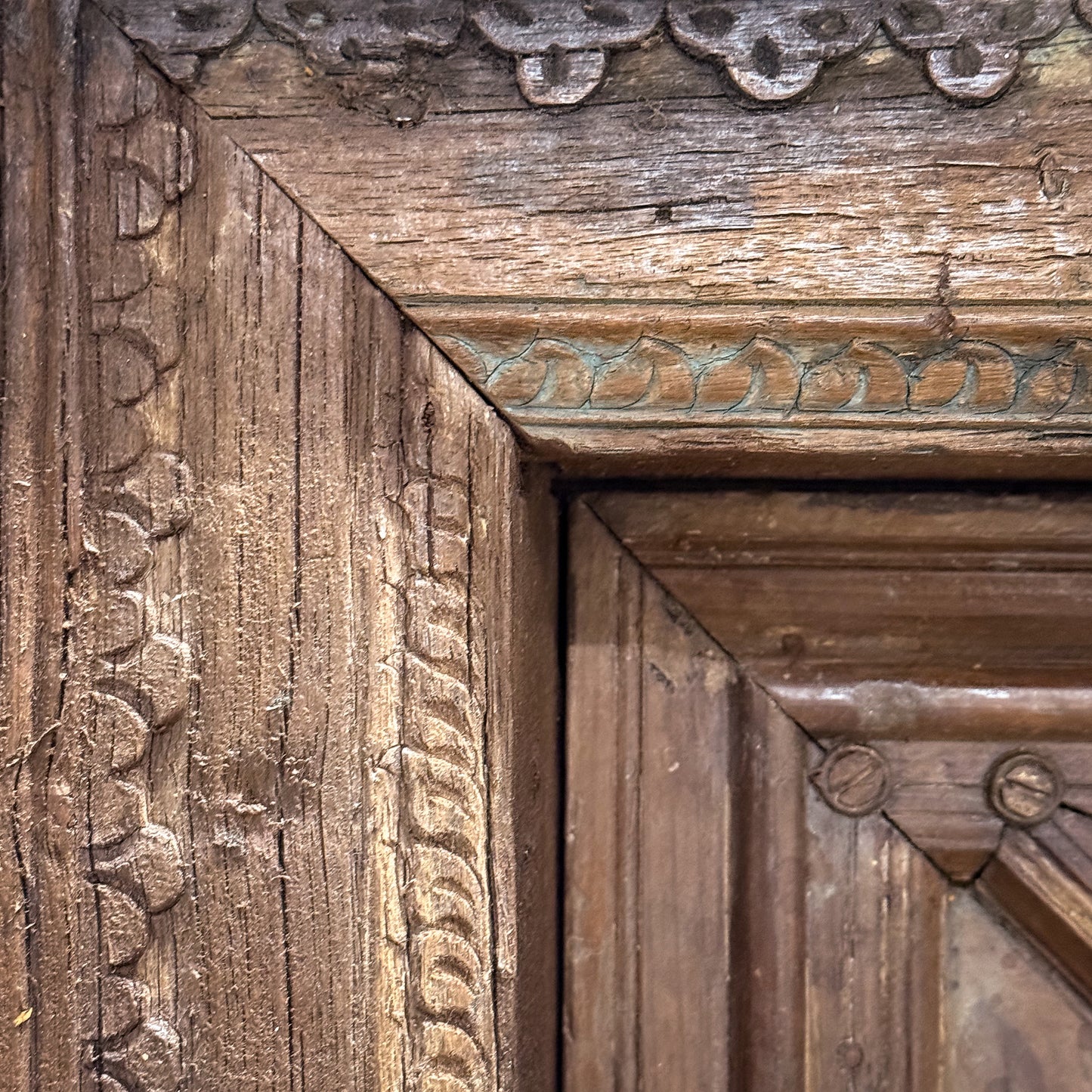 Close-up of an ornate wooden frame with intricate carvings.
