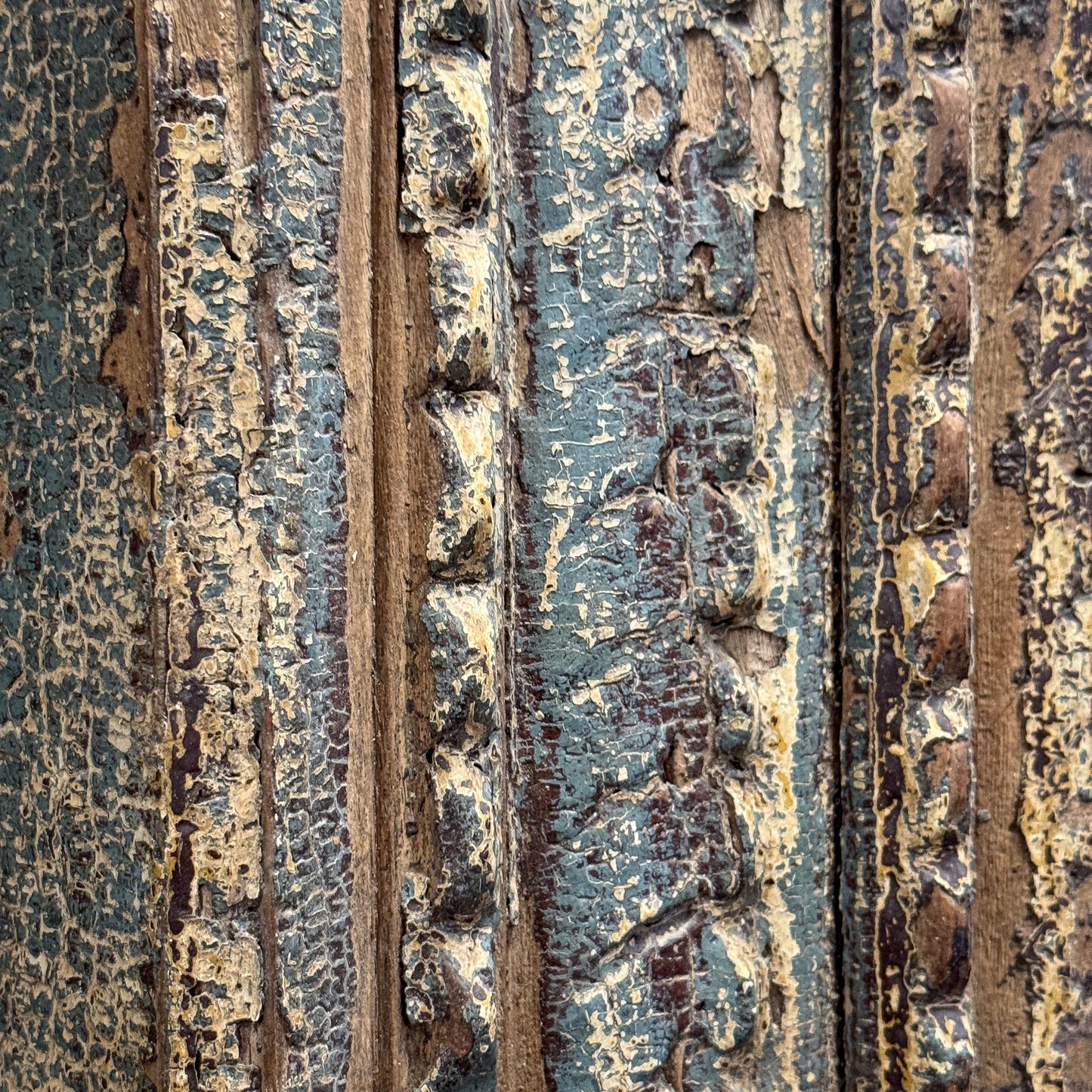Close-up of a textured surface with rust and peeling paint