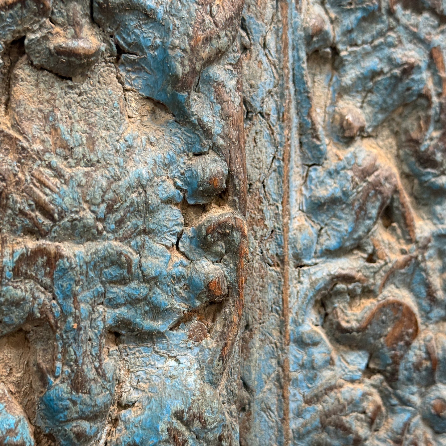 Close-up of detailed stone carvings with blue and brown hues