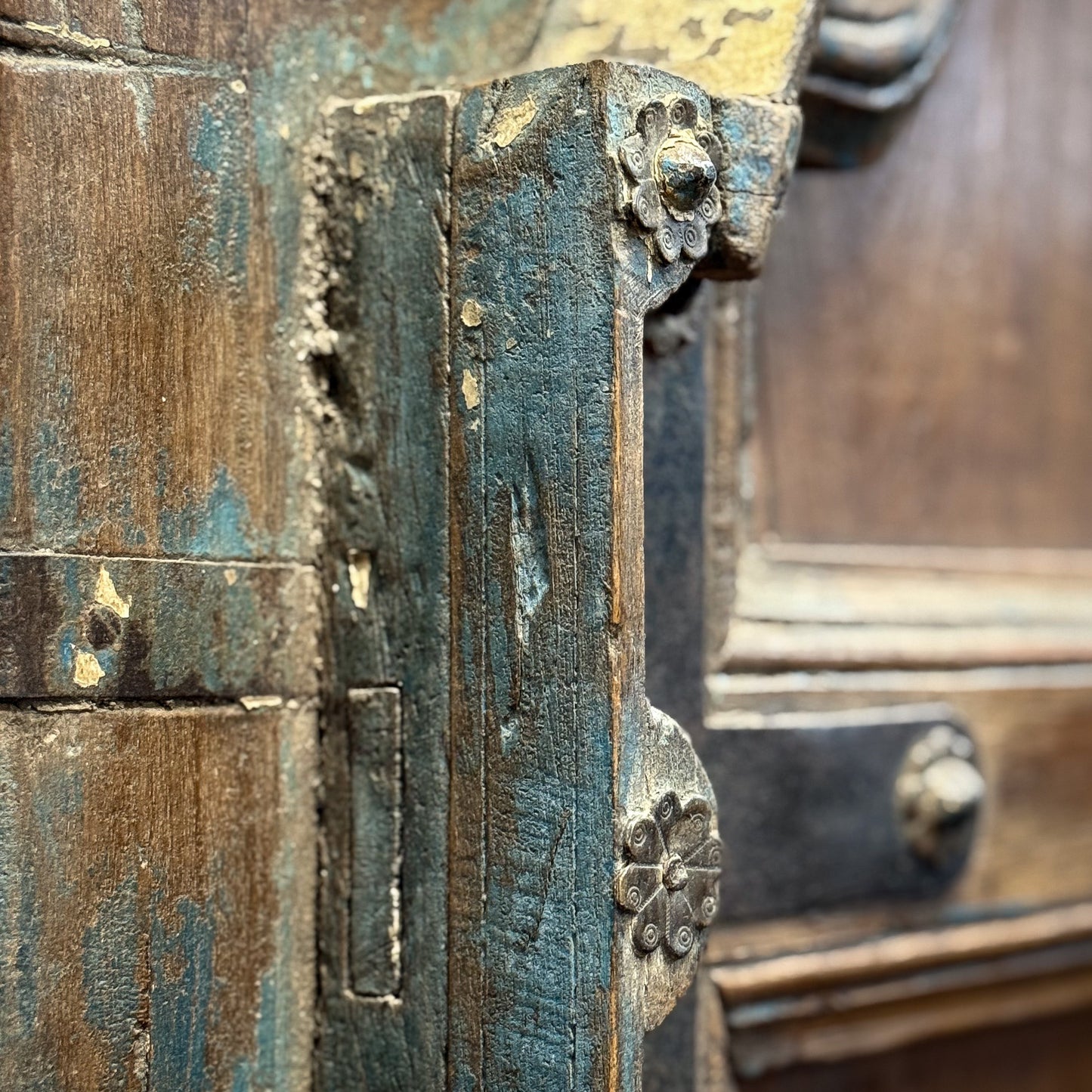 Close-up of a wooden architectural detail with floral carvings