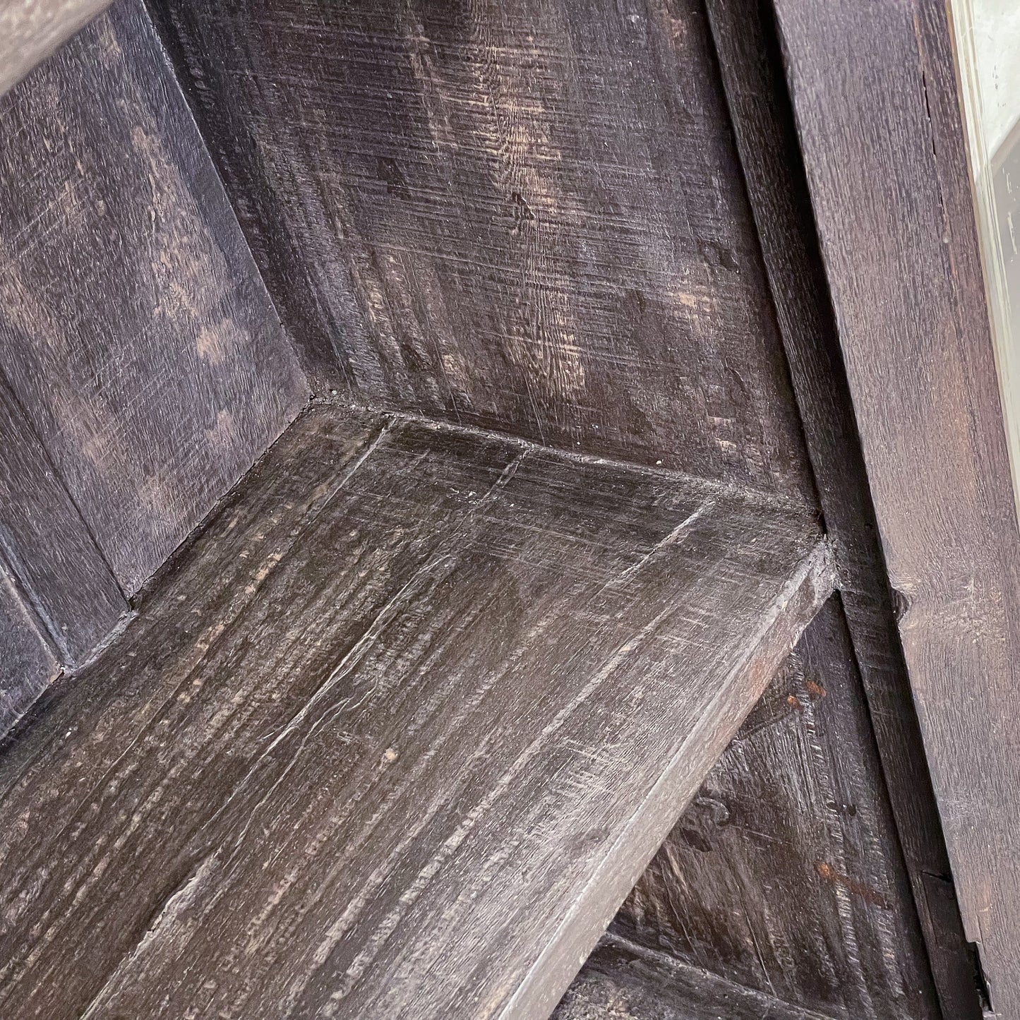 Close-up of a wooden bench with a rustic finish