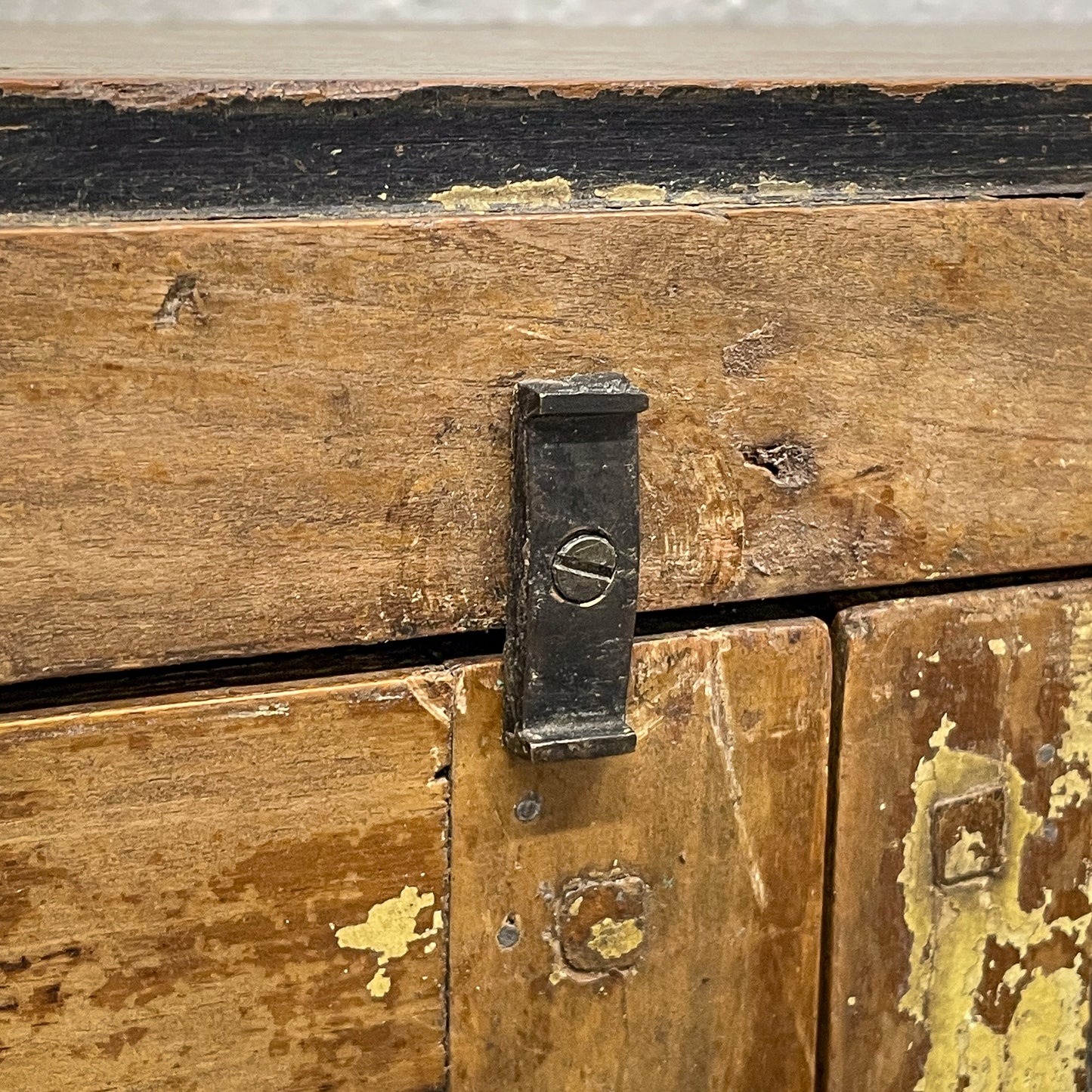 Close-up of a wooden chest with a metal latch