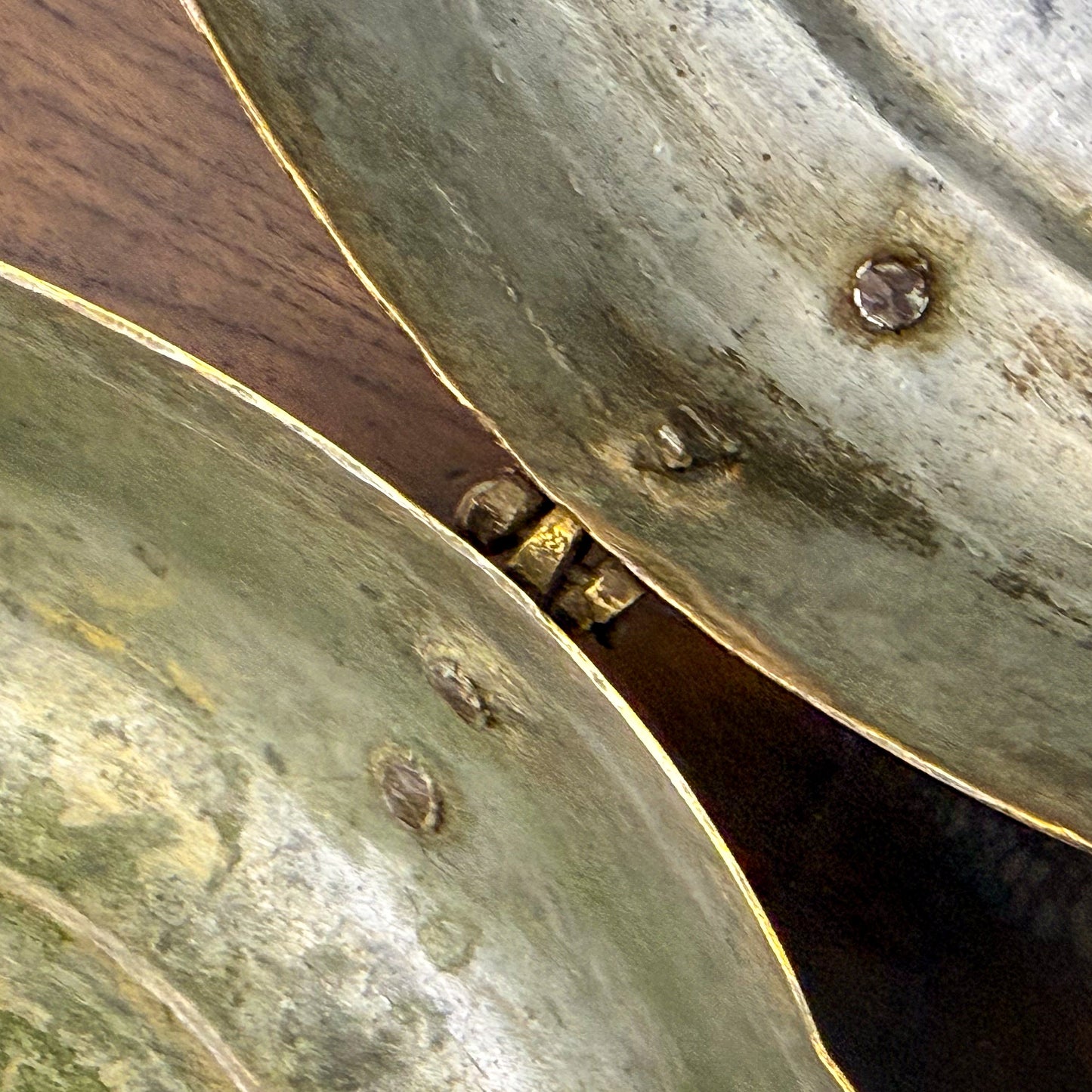 Close-up of two brass bowls with a wooden surface underneath