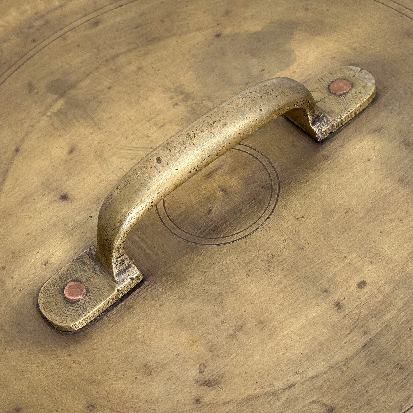 Brass handle on a wooden surface