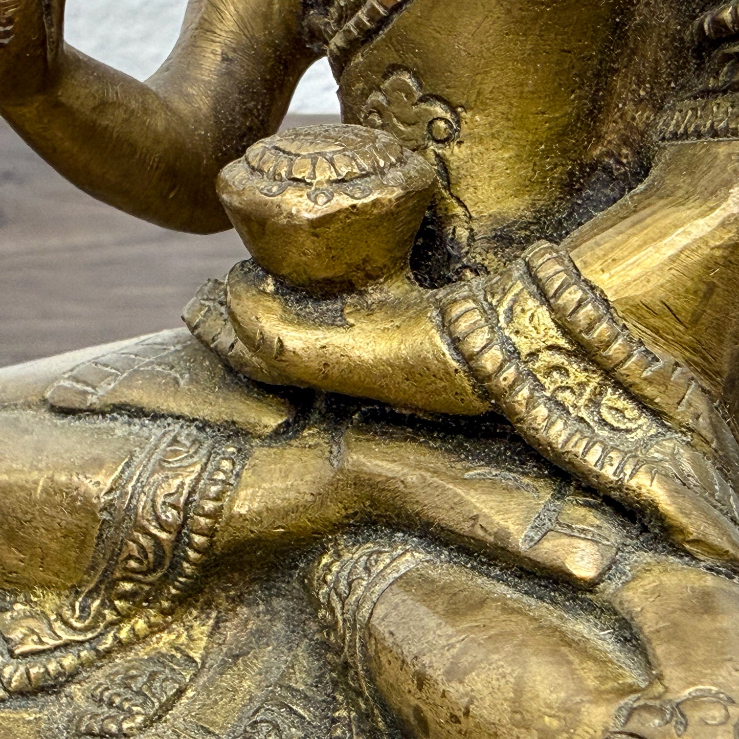 Close-up of a detailed bronze statue with intricate designs.