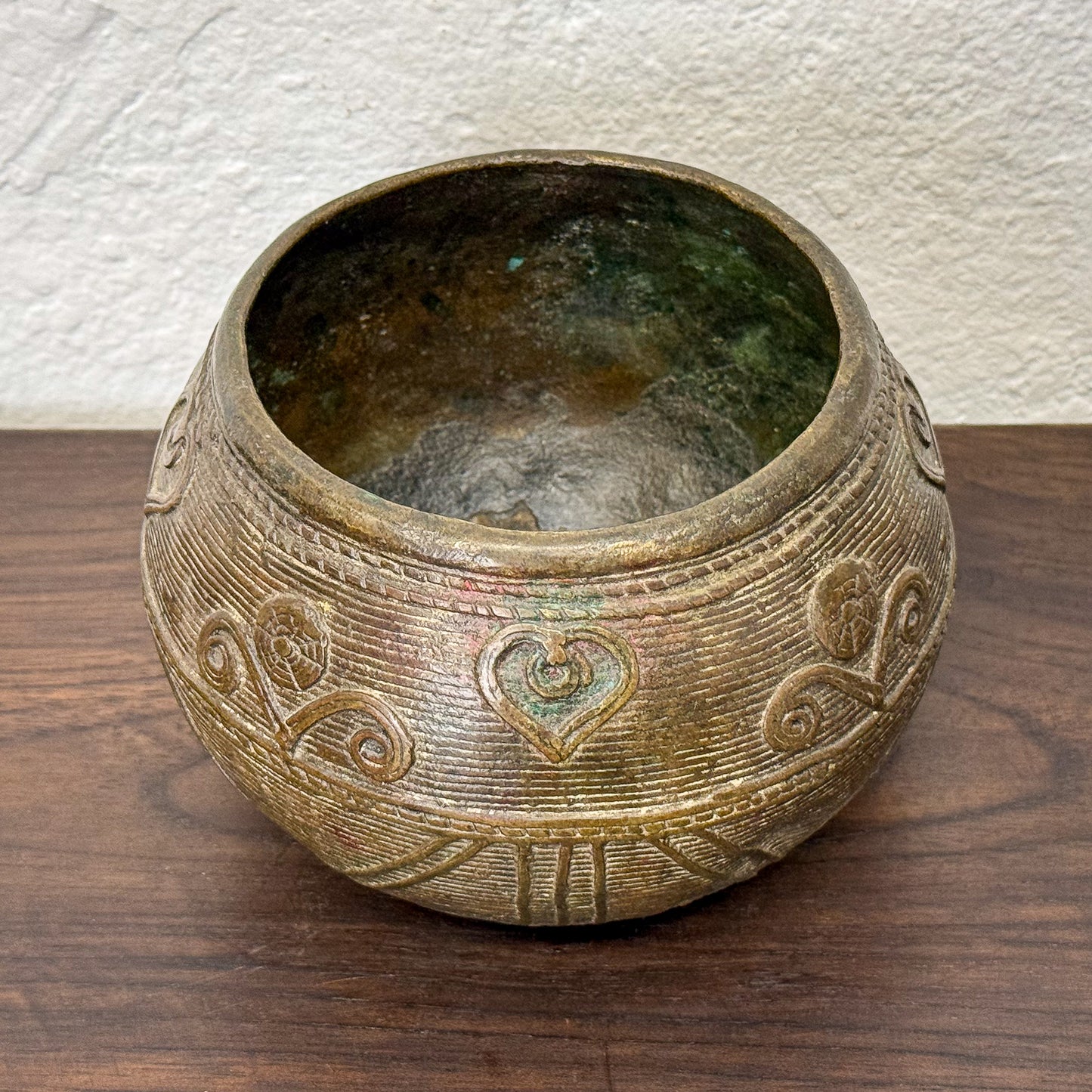 Decorative ceramic bowl with intricate patterns on a wooden surface