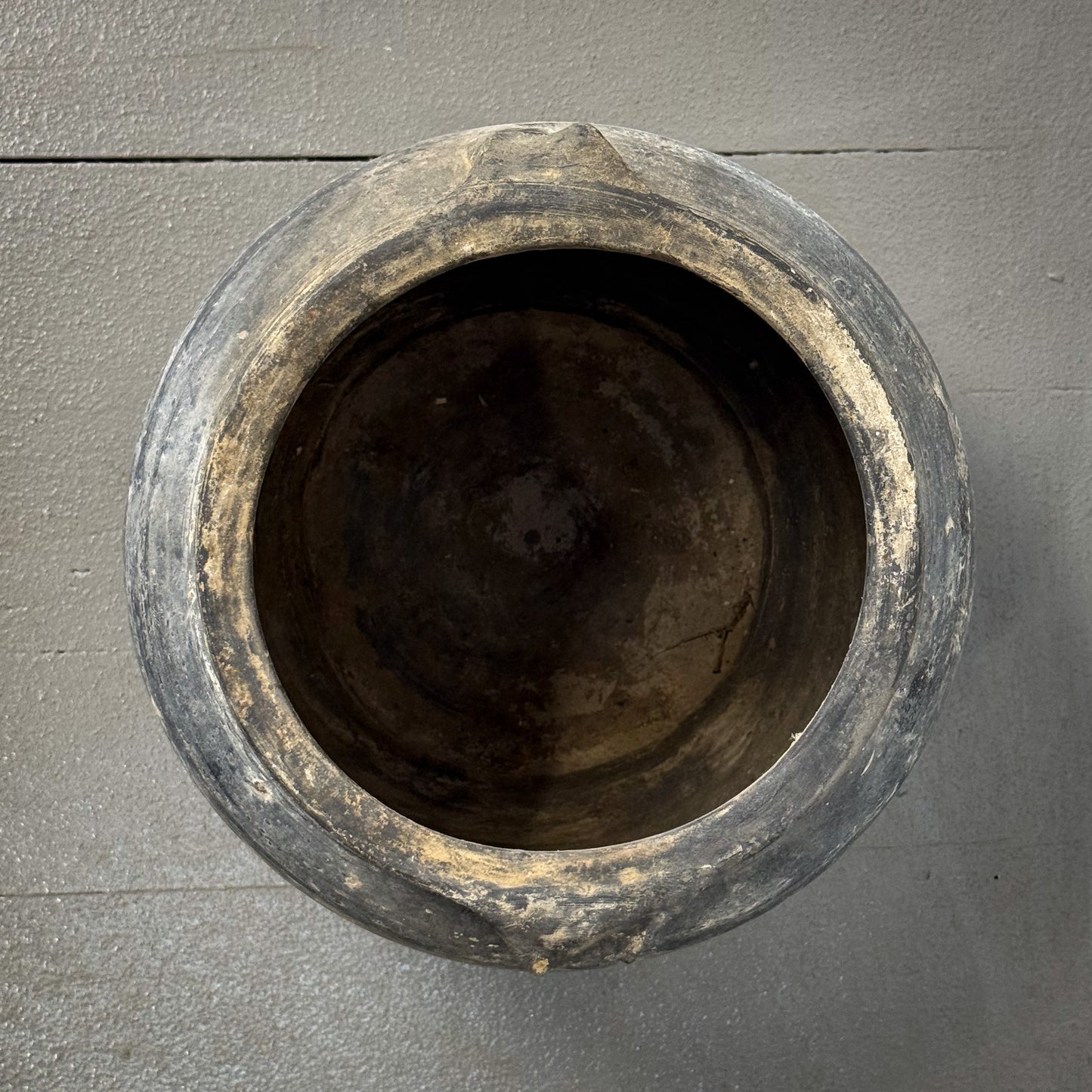 Black pot on a gray wooden surface