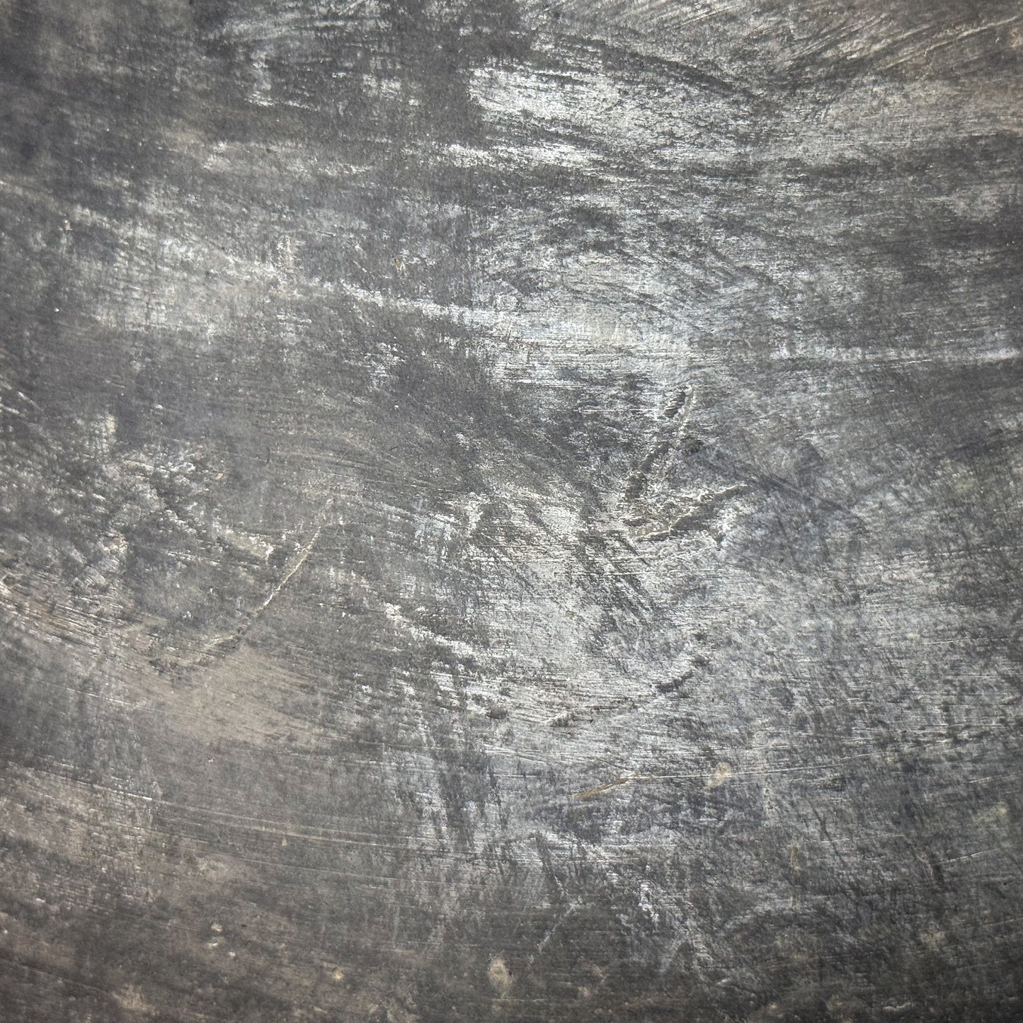 Textured gray surface with scratch marks