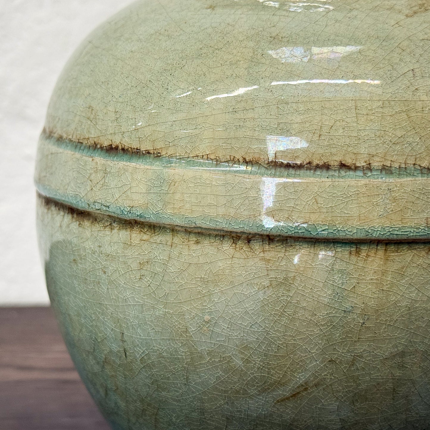 Close-up of a ceramic jar with a textured surface and visible glaze.