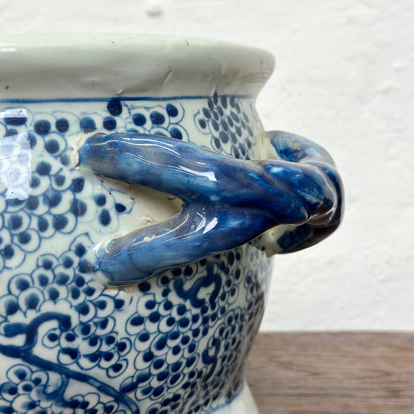 A blue and white porcelain baby bath with floral patterns