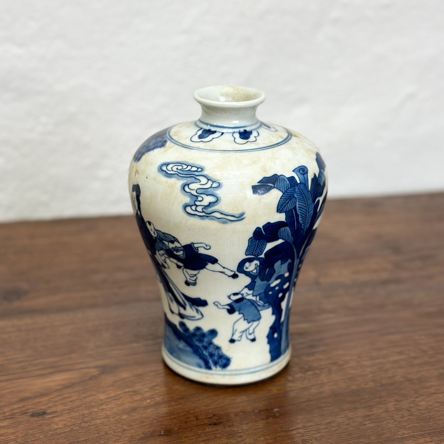 A blue and white porcelain meiping vase with floral patterns, displayed against a neutral background.