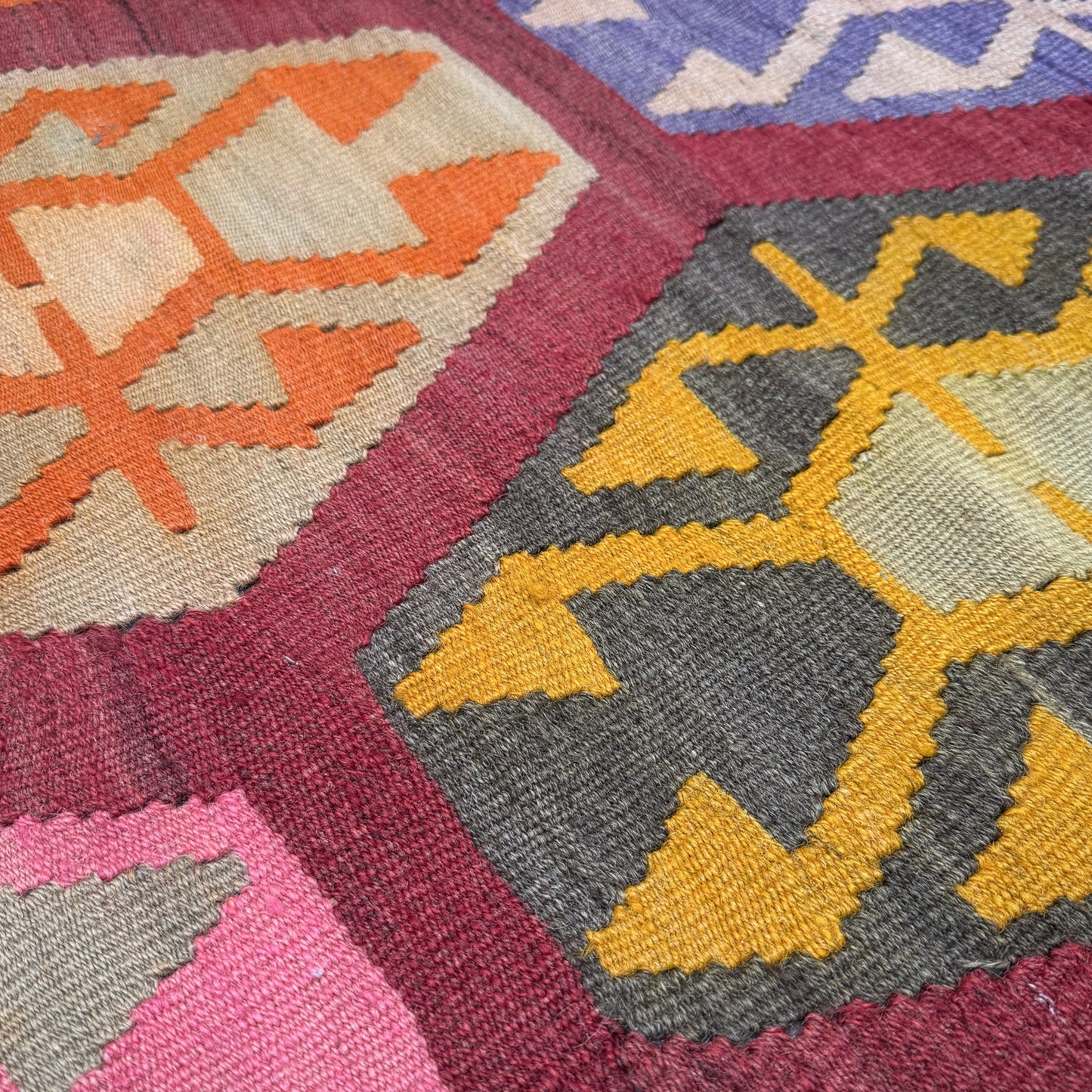 Close-up of a colorful geometric patterned fabric with vibrant colors.