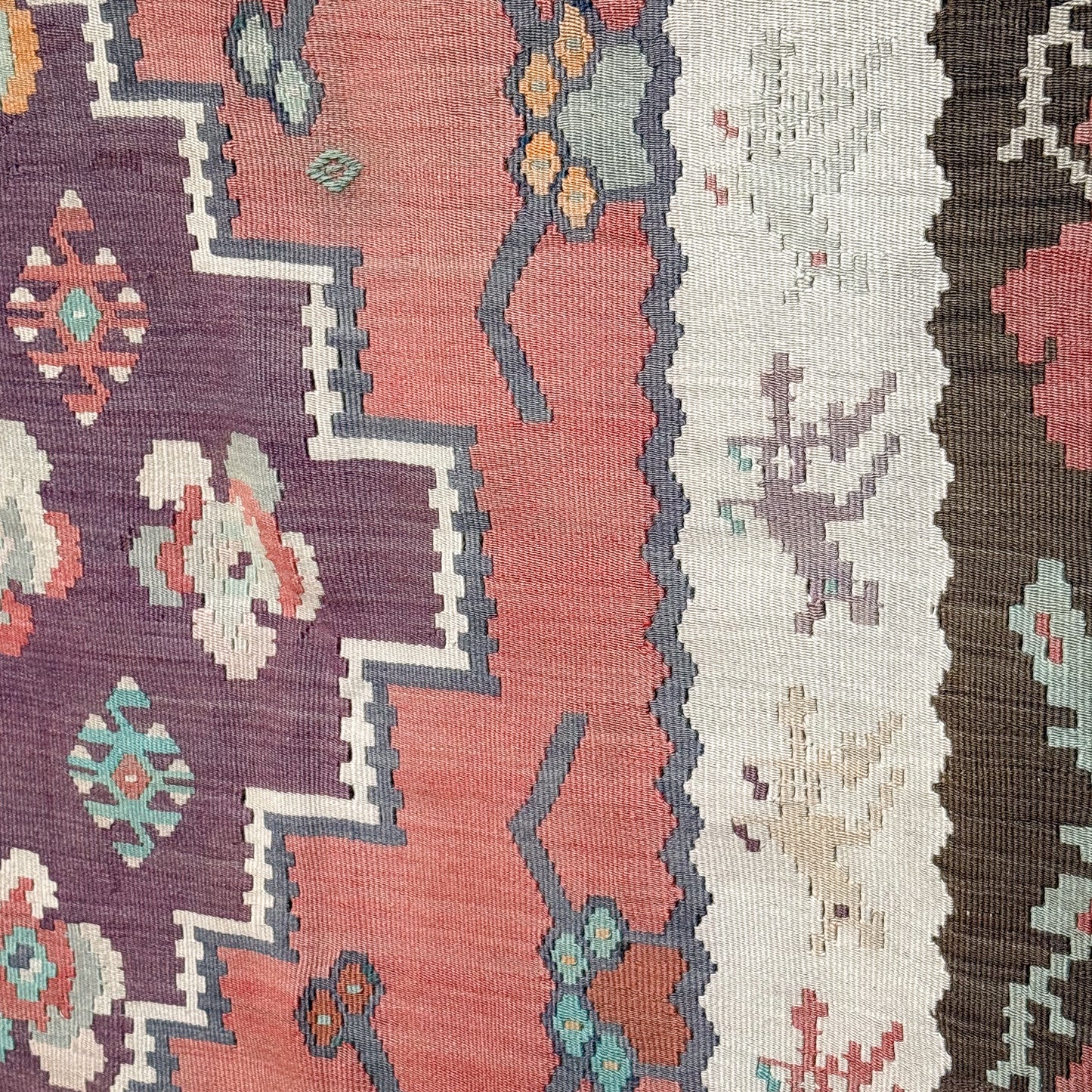 Close-up of patterned fabric with geometric designs in various colors.