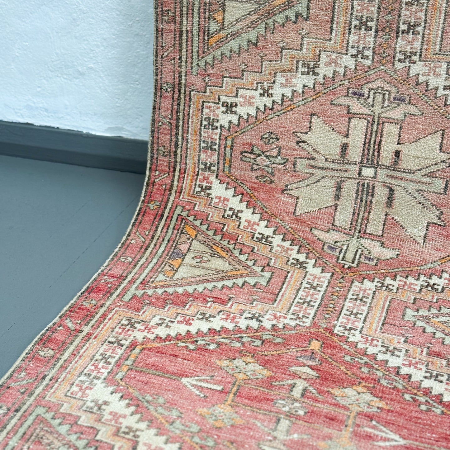 Close-up of a patterned rug with geometric designs on a plain background