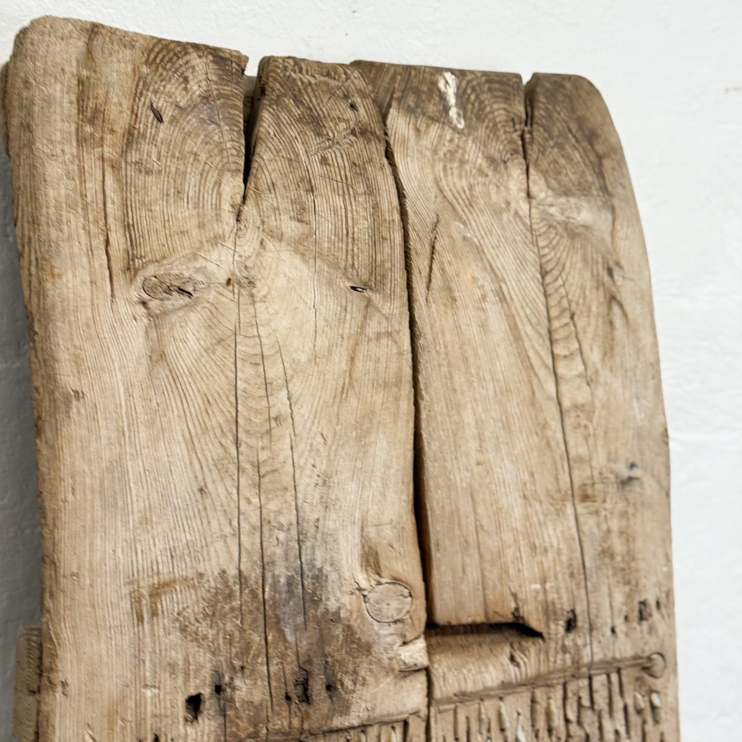 Rustic wooden panel with visible grain and texture on a white background