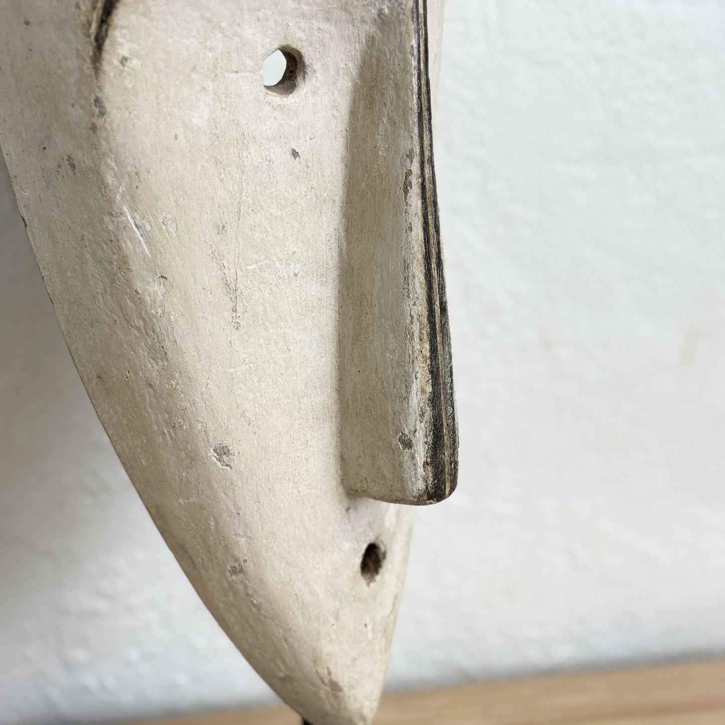 Close-up of a concrete wall hook with a neutral background