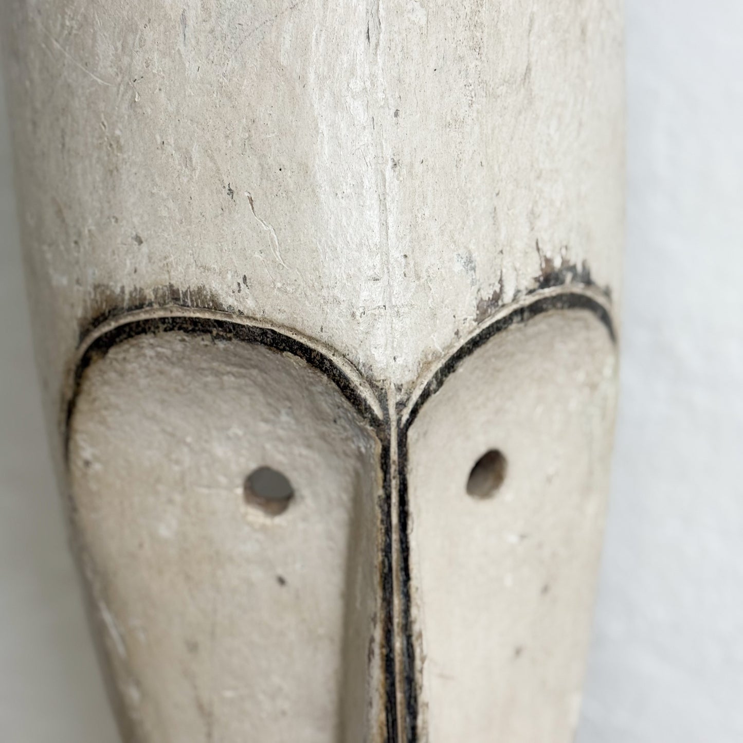 Close-up of a wooden object with a heart-shaped cutout on a white background