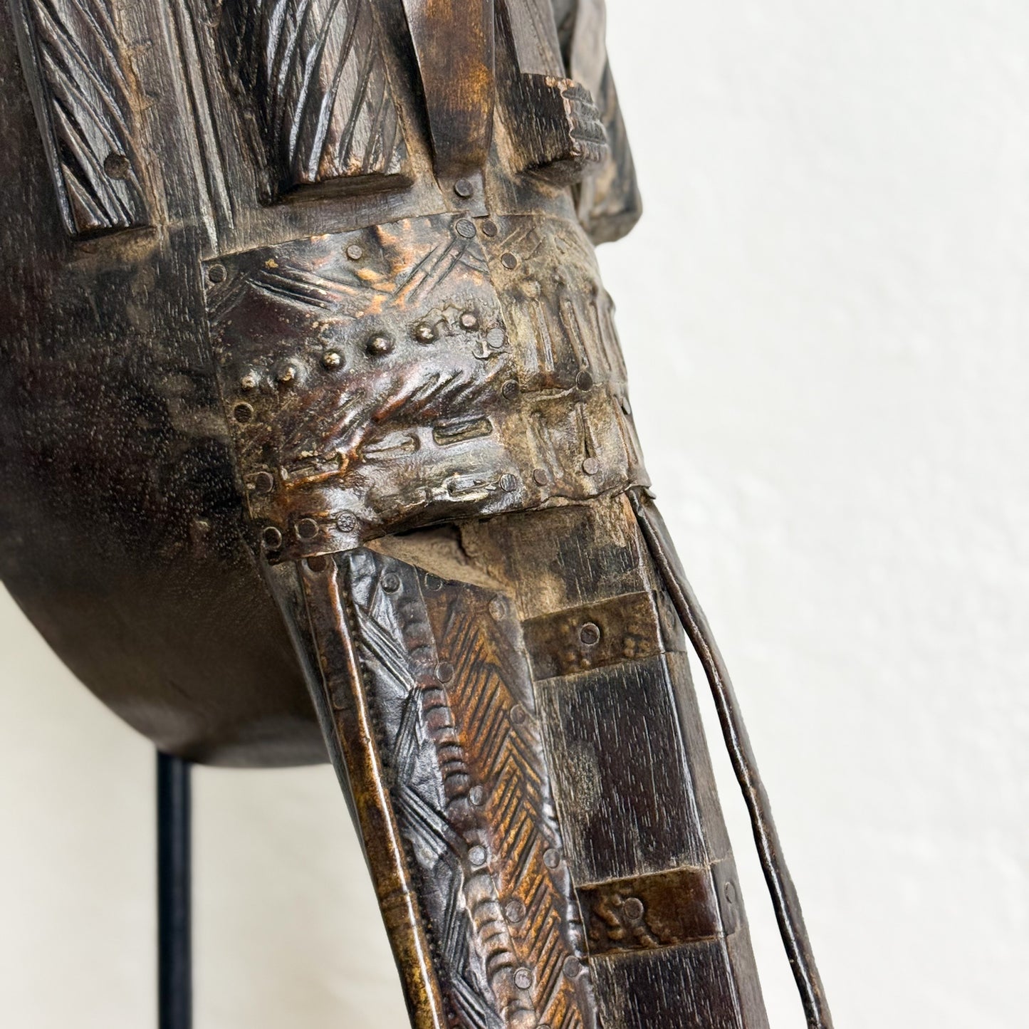 Decorative metal object with intricate designs on a white background