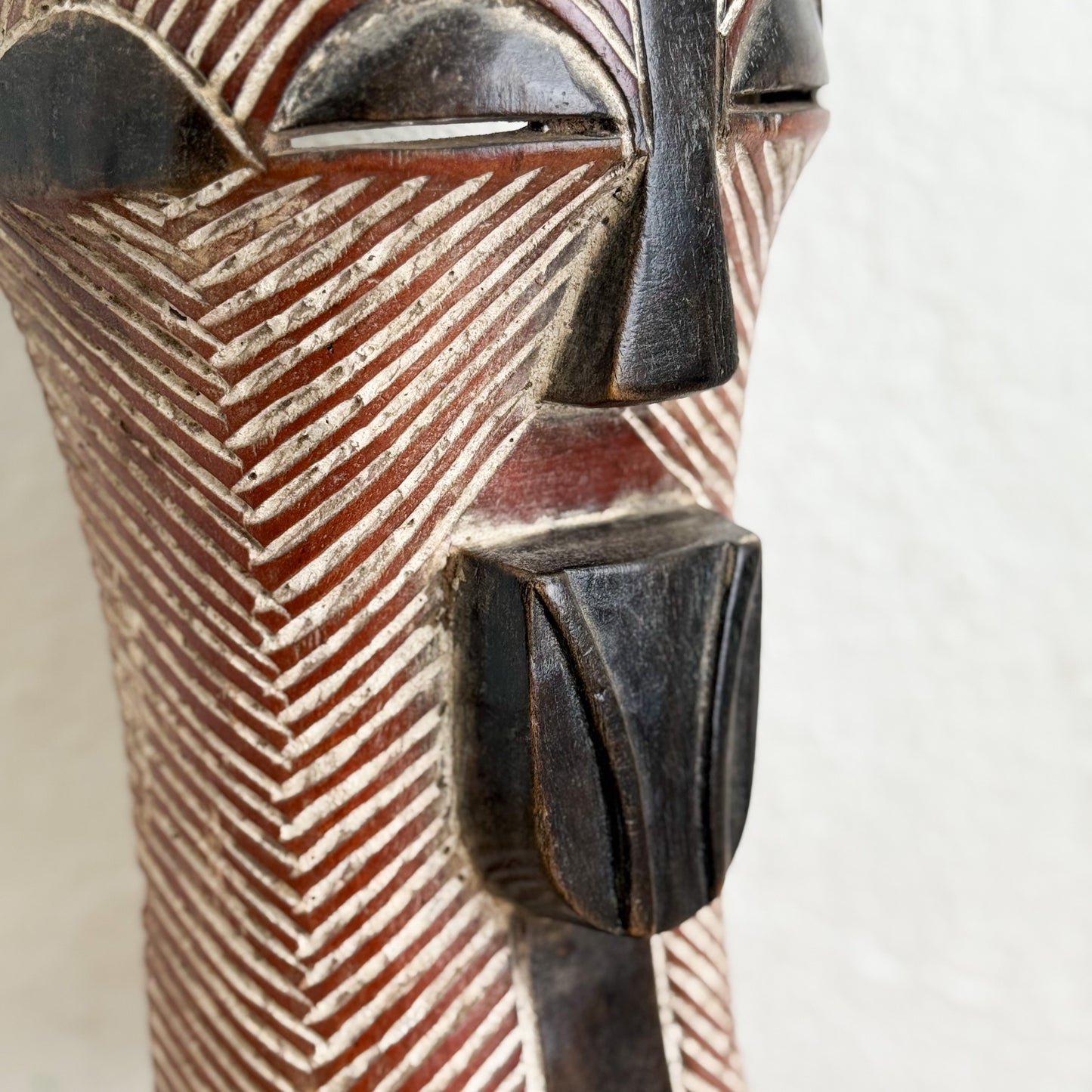Close-up of a decorative vase with geometric patterns on a white background