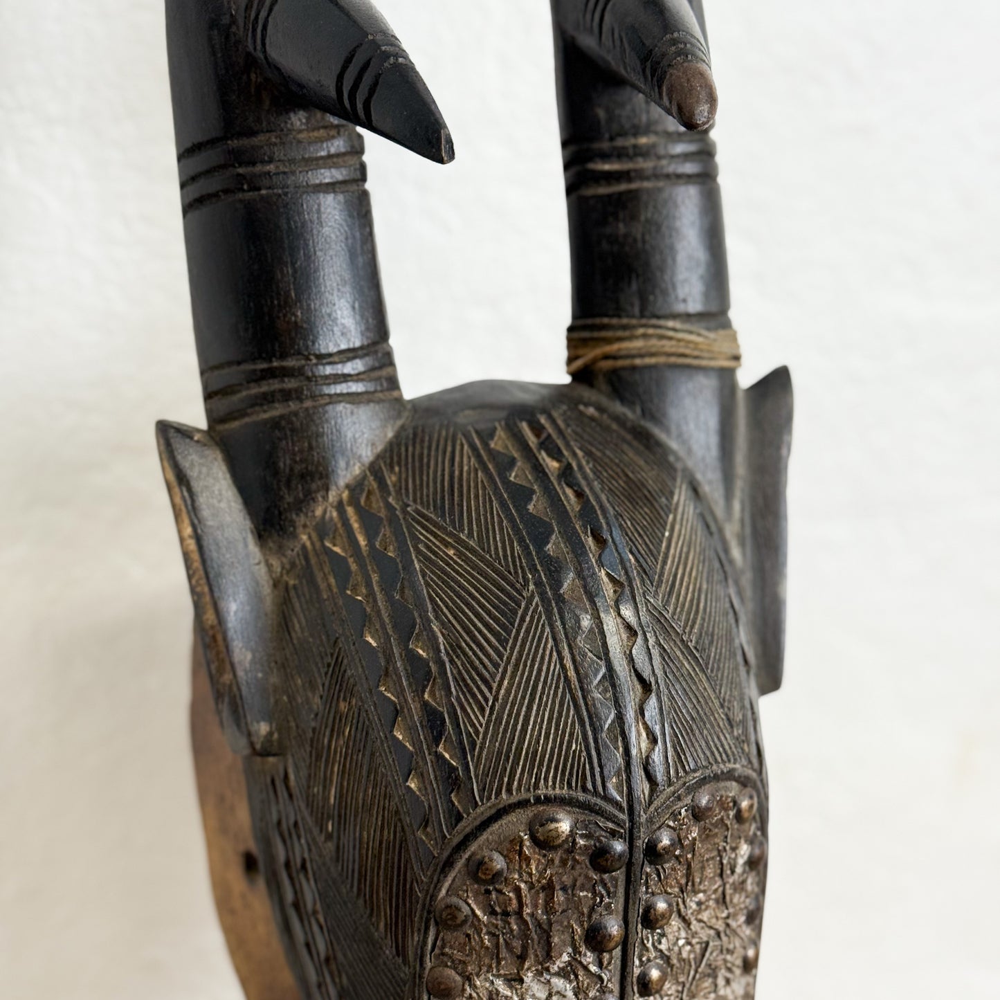 Decorative wooden object with intricate carvings on a white background