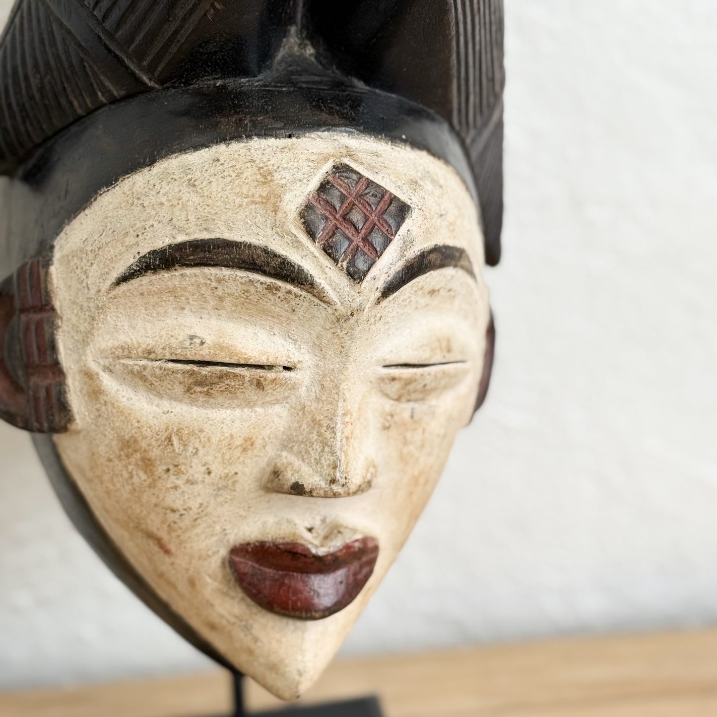 Close-up of an African mask with a plain background