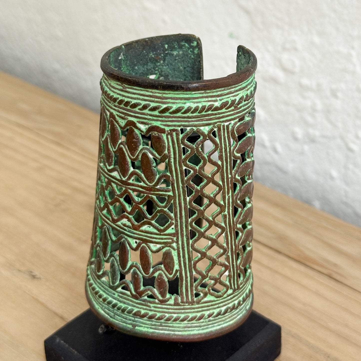 Decorative ceramic vase with intricate patterns on a wooden surface