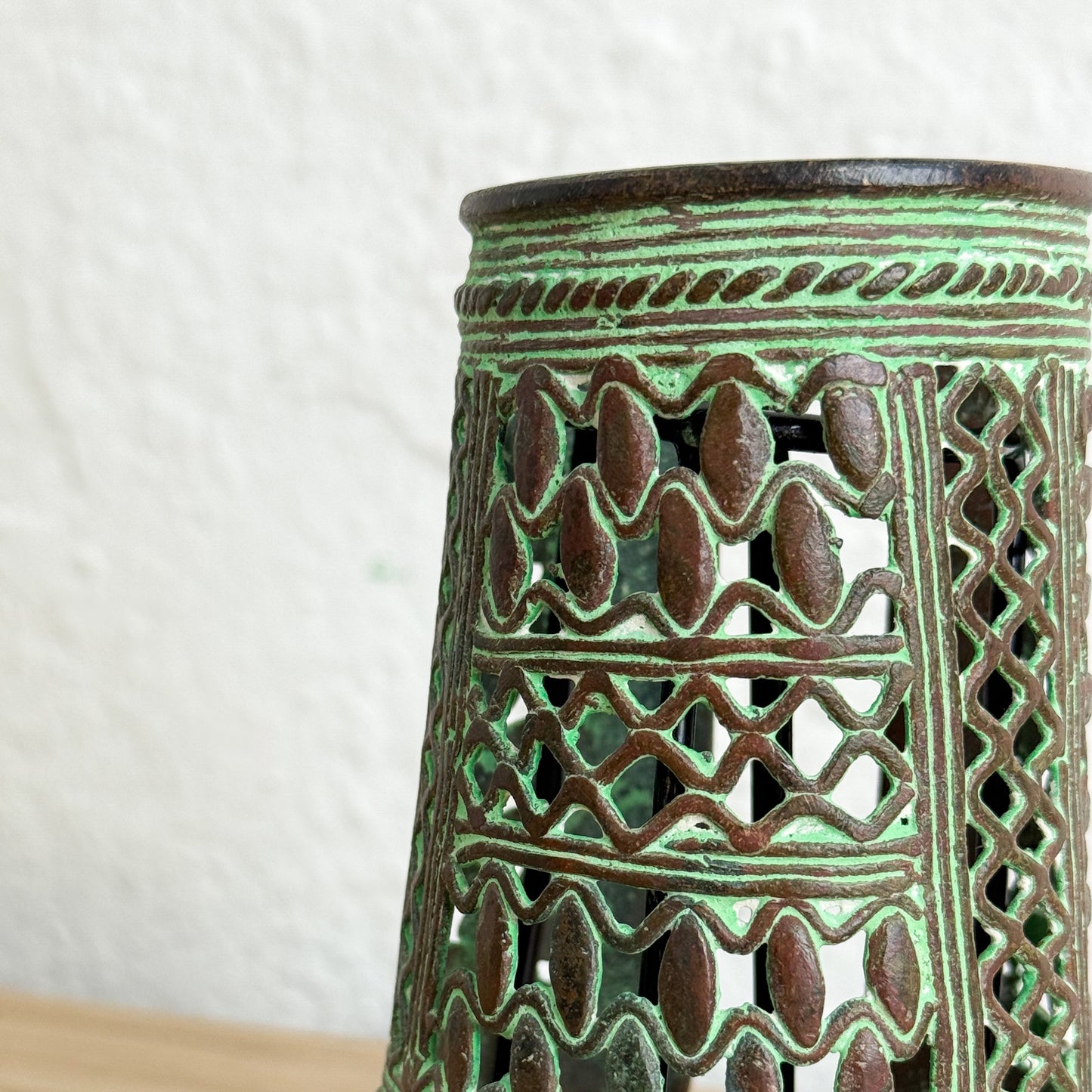 Decorative ceramic lantern with intricate patterns on a white background