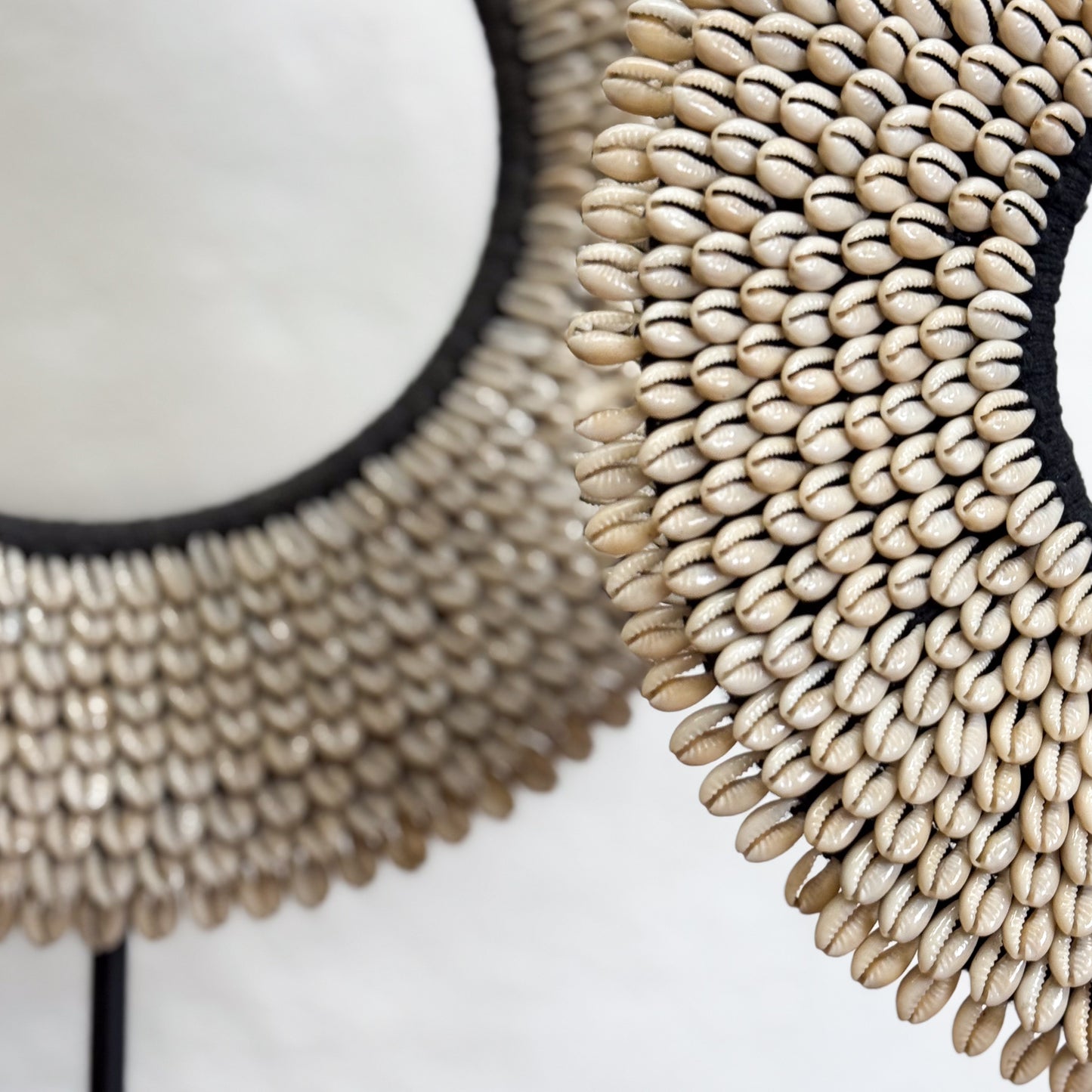 Decorative wall mirror with shell-like design on a white background