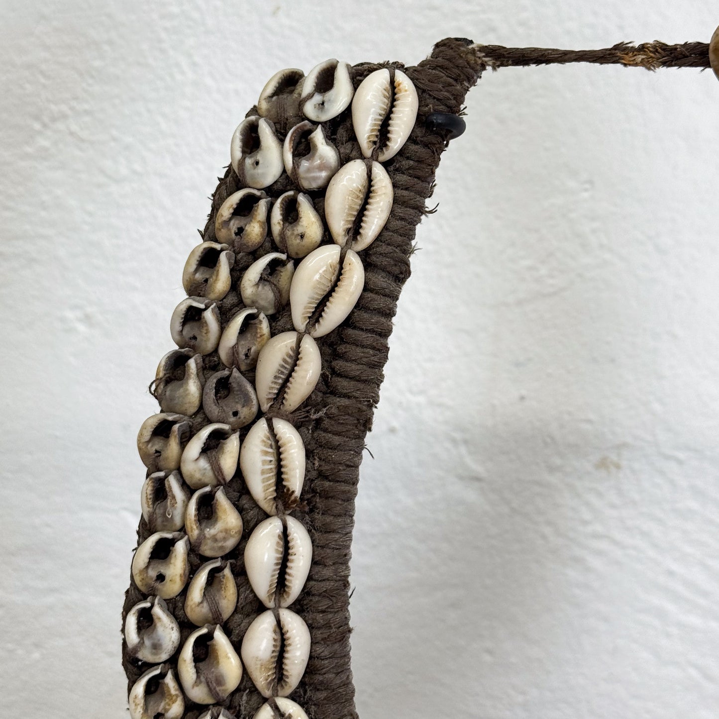 Decorative item with cowrie shells on a white background