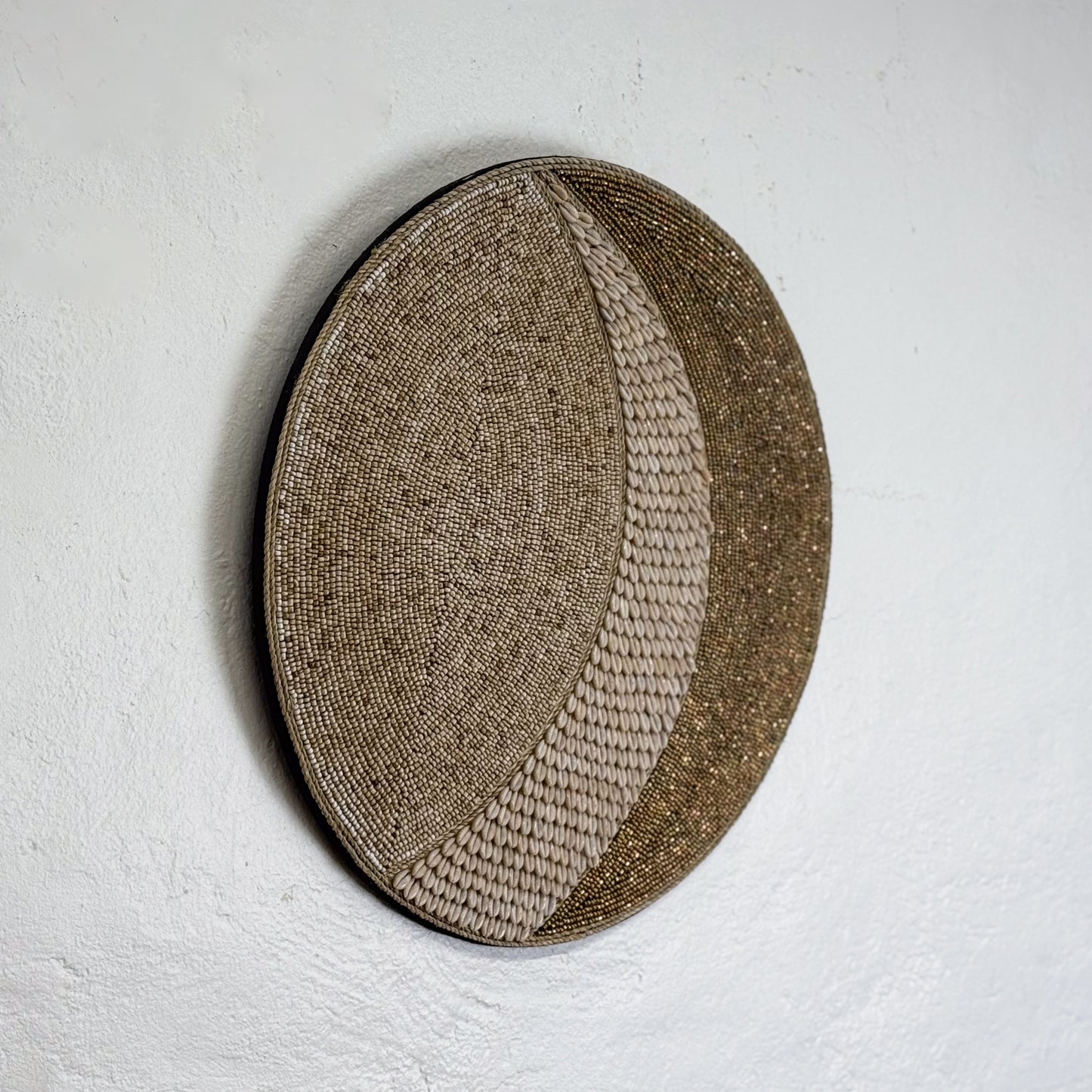 Round woven basket with a natural pattern on a light gray background